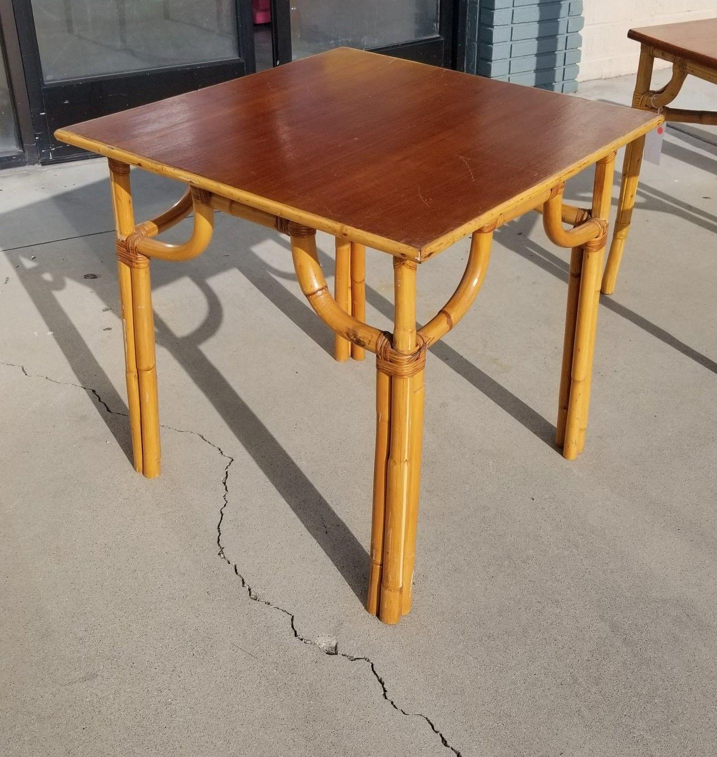 Restored rattan mid-century four-person square dining table resting on three single strands 