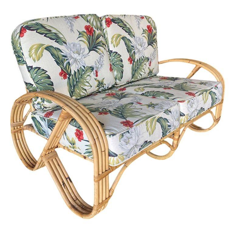 This round 3/4 pretzel rattan living room set features 2 lounge chairs, a settee, and a matching stacked rattan ottoman with a cushion top. The set is wrapped in a cloth palm leaf floral upholstery.

Measurements:
Settee: 48