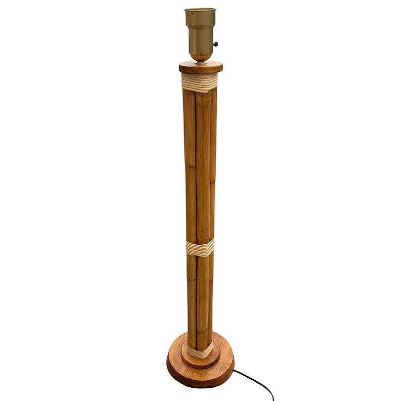 This beautifully restored Art Deco rattan lamp is a standout example of mid-century tropical style, blending style and vintage charm with modern comfort. Featuring a distinctive four-strand rattan body, the lamp sits on a bold stepped round wood