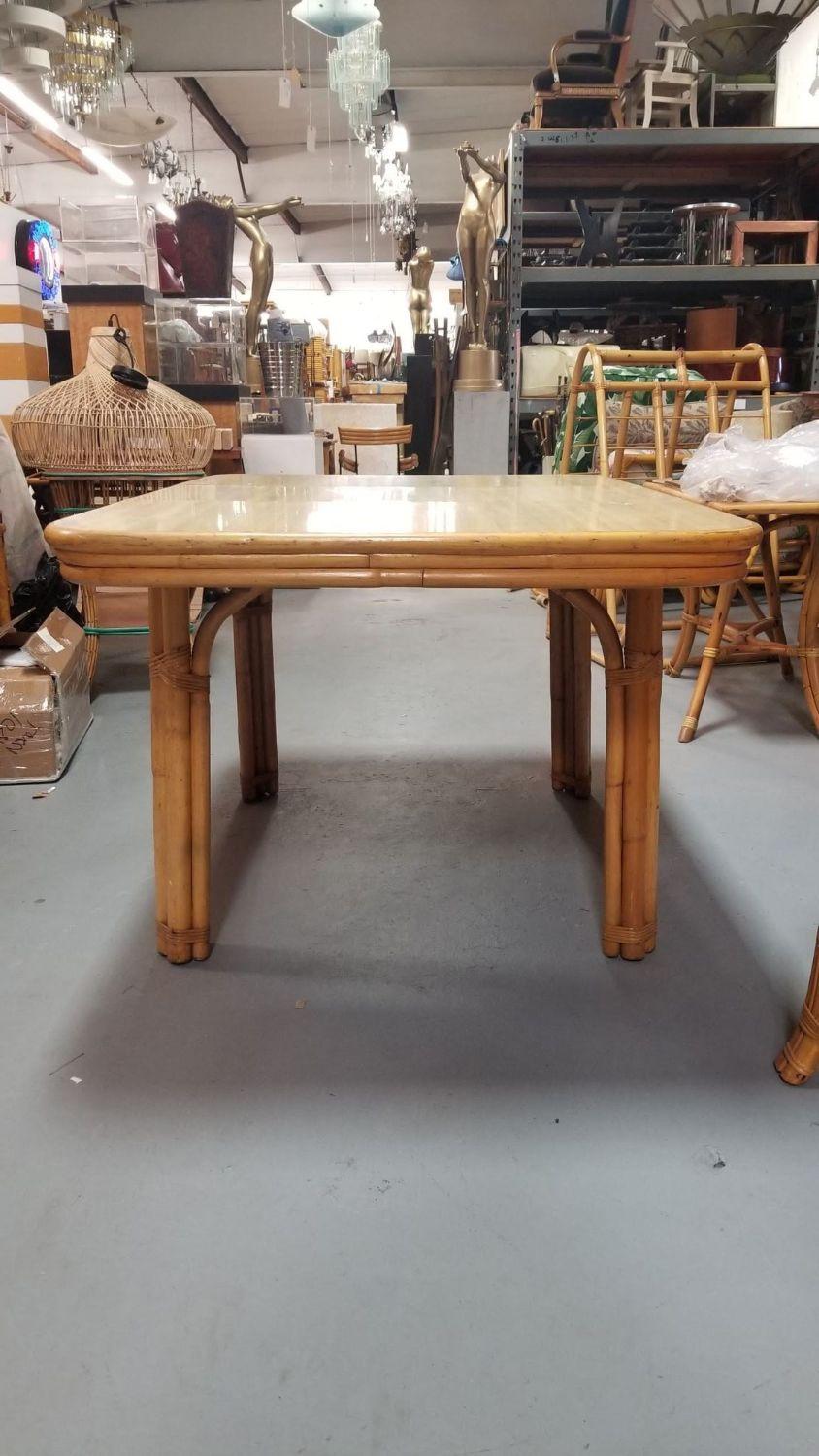 Mid-Century restored rattan dining table with a light wood color Formica top and a middle removable leaf. Measurements and photos are taken at full length with leaf.

Without the 16
