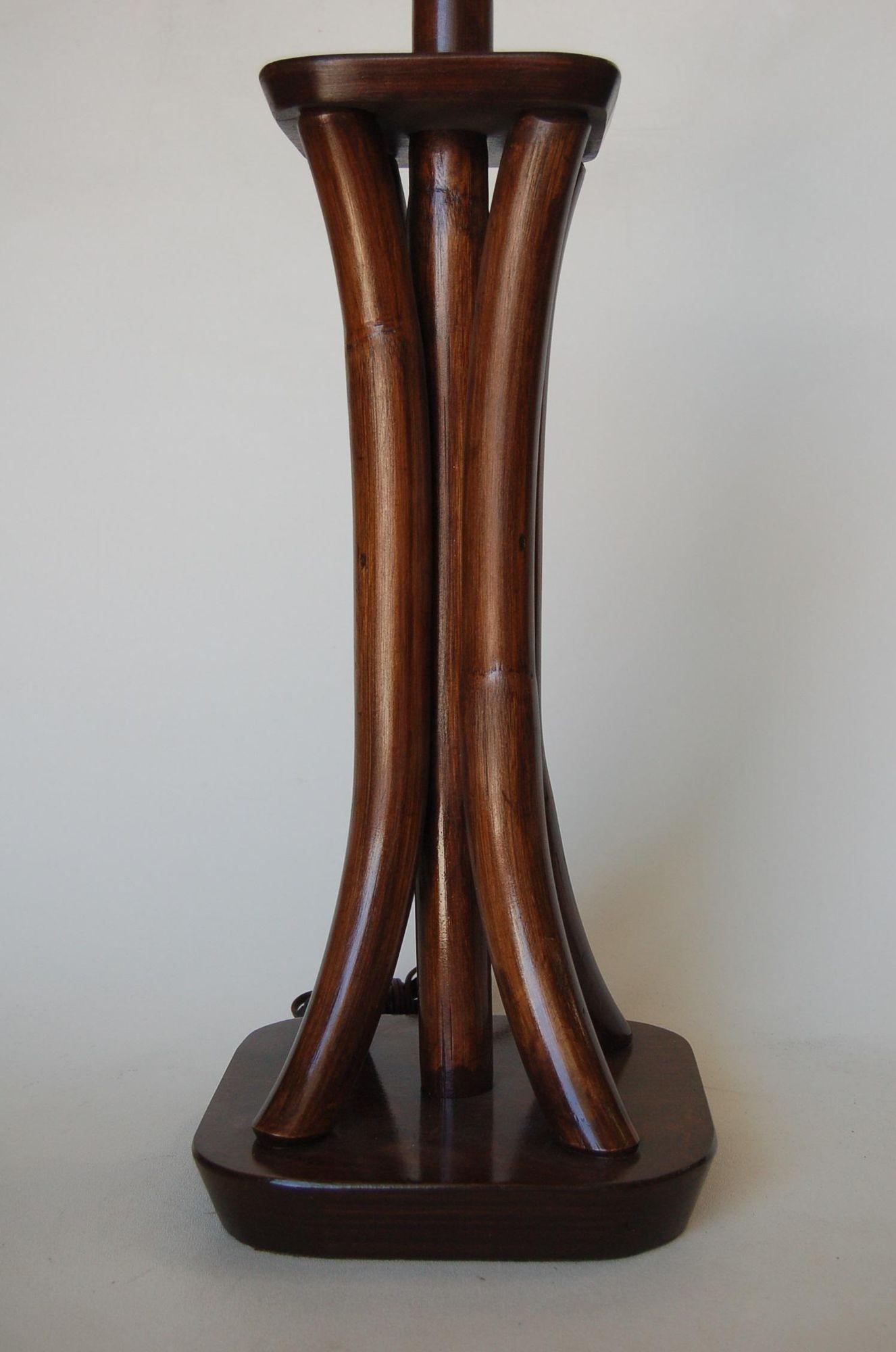 Restored Four Strand dark stained rattan bent pole table lamp with mahogany bases.

Measures 8.5 