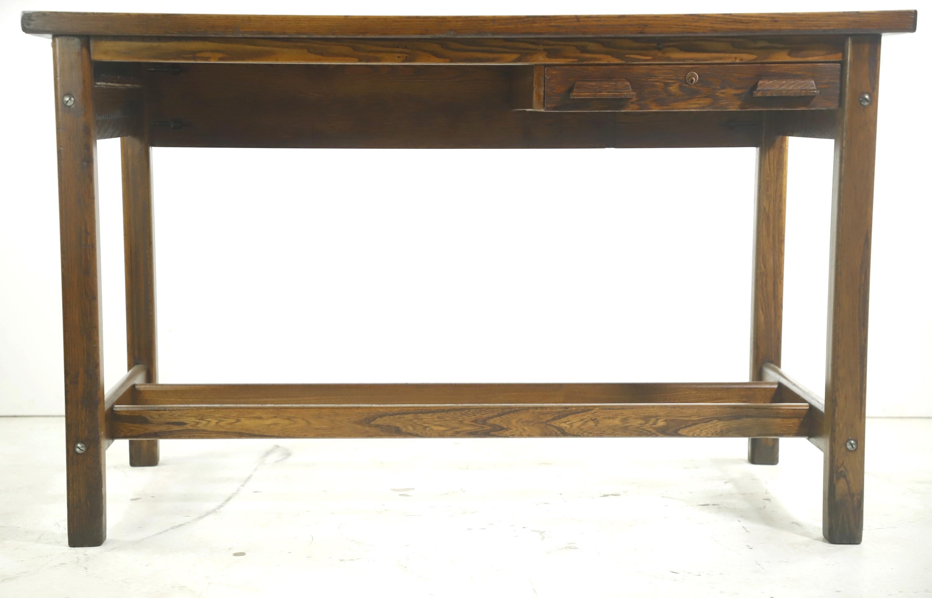 Early 20th century medium tone solid oak counter height work table or desk with one right side drawer. Restored and refinished. Labeled J250 14-48. Made by Hamilton Manufacturing Company in Two Rivers, WI. Please note, this item is located in one of