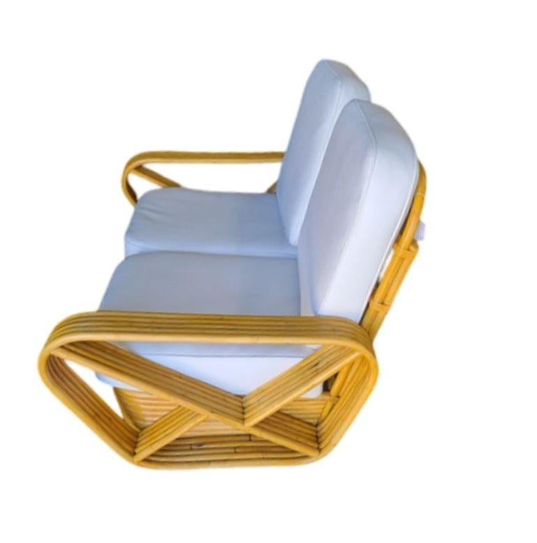 Designed in the manner of Paul Frankl this Five-strand rattan Sectional Setee features square pretzel arms and the classic stacked rattan base.

Cushions are made to order, and can be made in White Naughyde or COM fabric if provided.

1950, United
