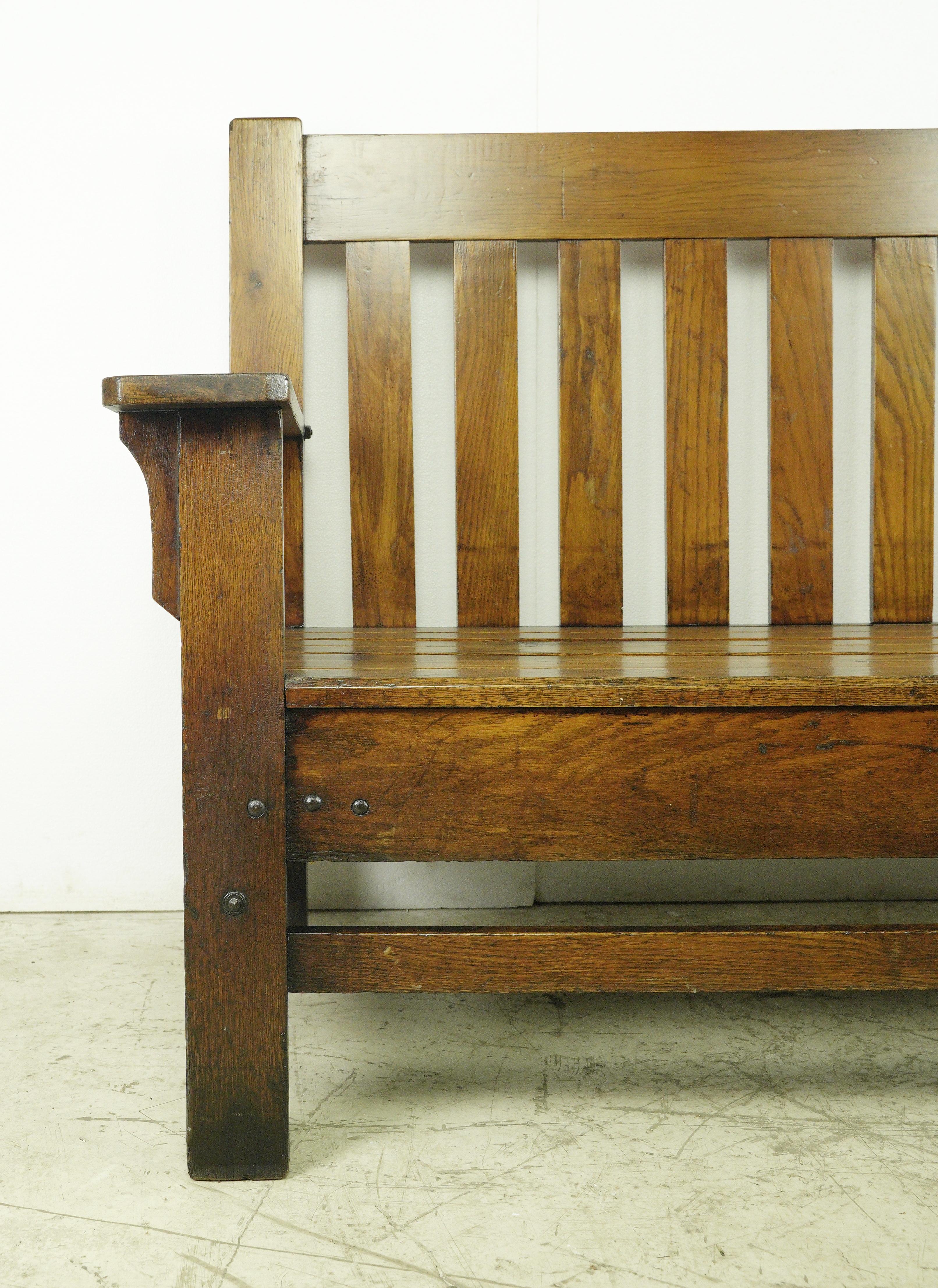 This large bench, crafted in the Mission style, exudes sturdiness and timeless appeal. Ideal for a restaurant waiting area or expansive home seating, its substantial size makes a statement. The restoration process preserved much of the original