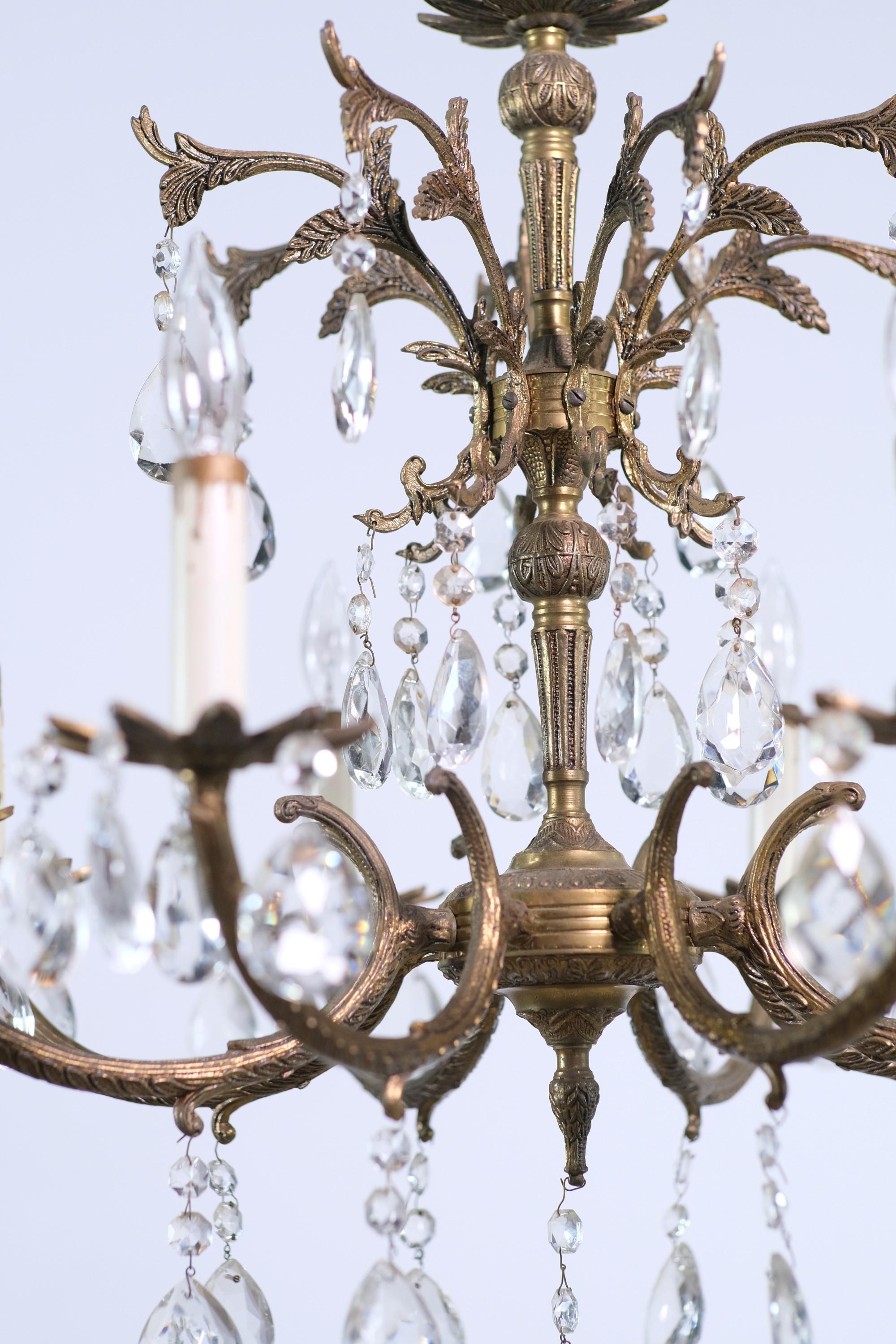 Antique early 20th Century small scale bronze finish chandelier. Each of the 8 arms takes one candelabra size light bulb. This can be seen at our 400 Gilligan St location in Scranton, PA.