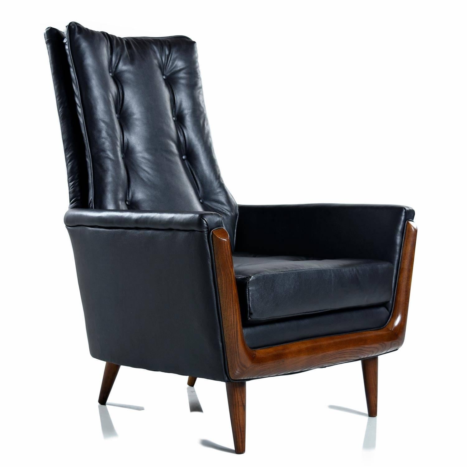 Dashing, masculine and sophisticated. Completely restored by our in-house cabinet shop and upholsterer who mimicked the original button tuft pattern. The chair is unmarked, but the sleek design shows strong influence from Adrian Pearsall . View from