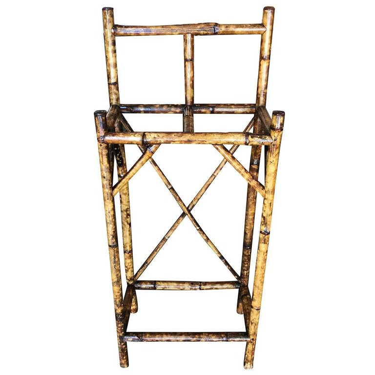 Antique tiger bamboo umbrella stand with back rail, featuring two slots for storing umbrellas and canes.

Restored to new for you.

All rattan, bamboo and wicker furniture has been painstakingly refurbished to the highest standards with the best