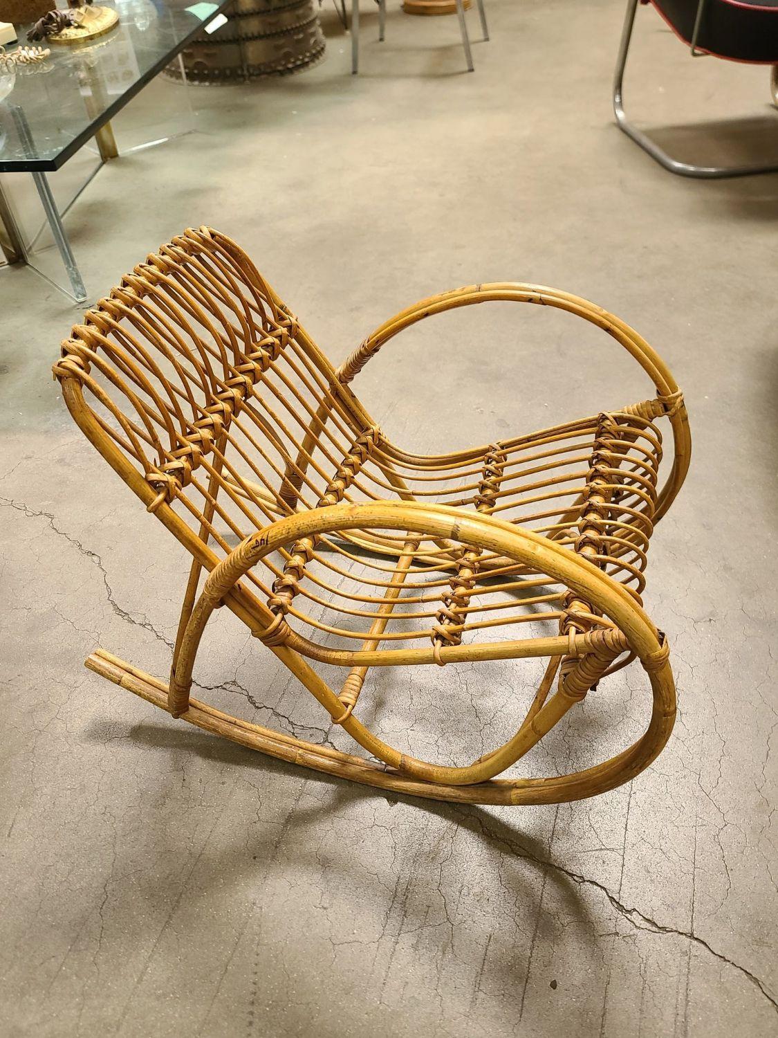 Rare Child size oversized Franco Albini-style two-strand round arm stick rattan rocking chair featuring large loops forming both the armrest and the rocker's rails.
1960, Italy
We only purchase and sell only the best and finest rattan furniture