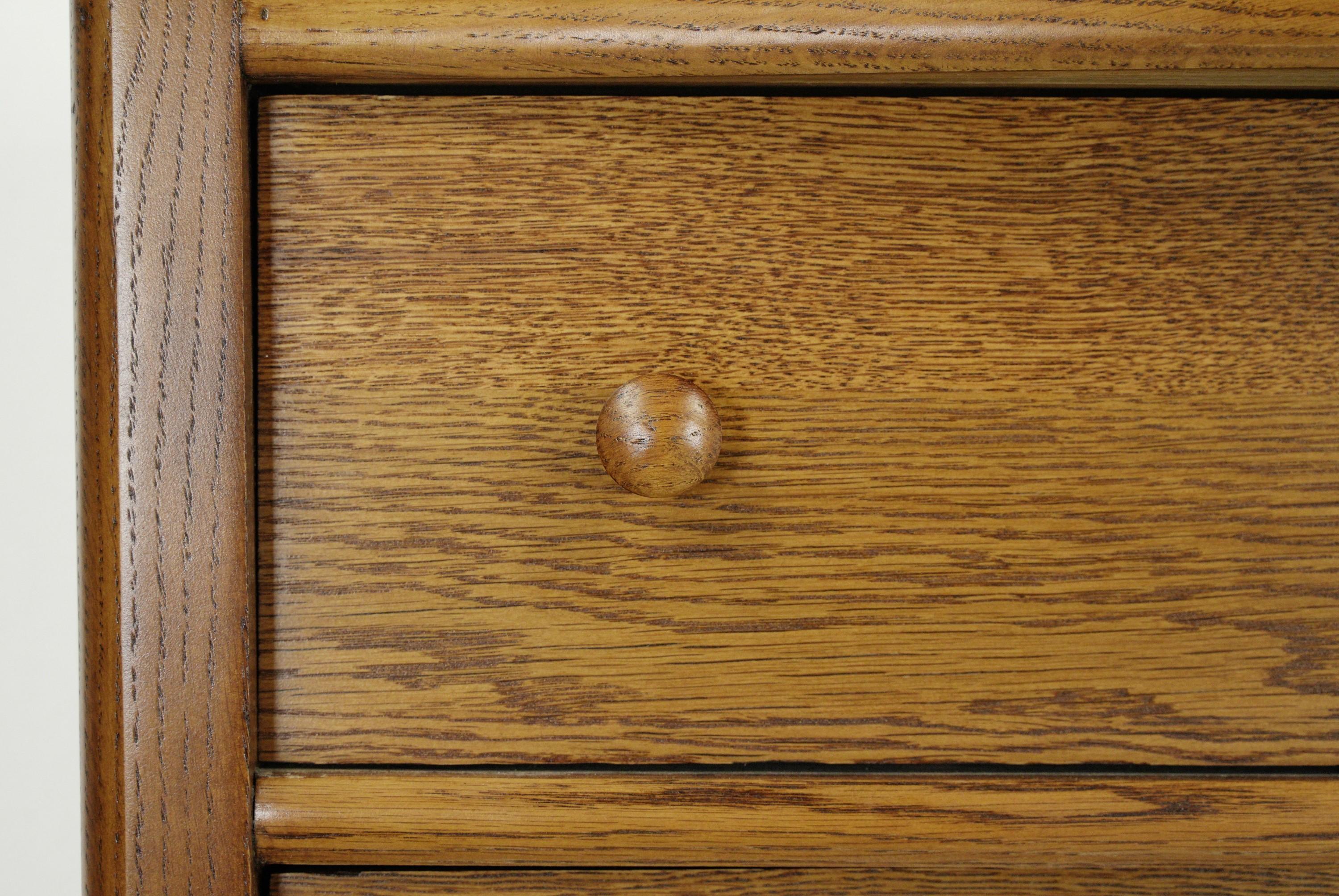 Restored antique medium tone oak high boy dresser with 6 dovetailed drawers and casters. This piece was restored in our shop. Good condition with appropriate wear from age. One available. Please note, this item is located in one of our NYC locations.