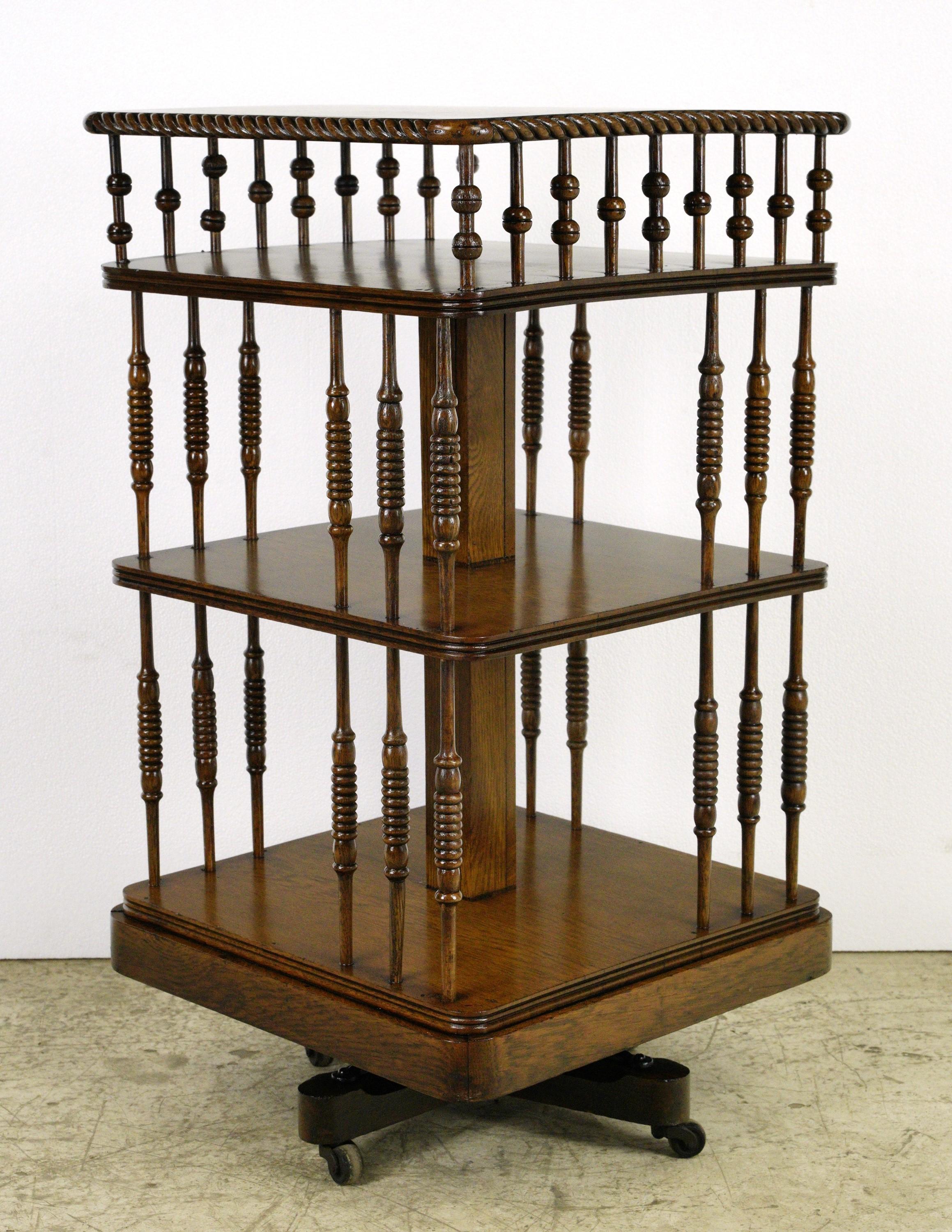 Antique free standing three tier revolving bookcase with spindle supports. This piece was restored in our shop. Good condition with appropriate wear from age, with some repairs made. Please note, this item is located in one of our NYC locations.