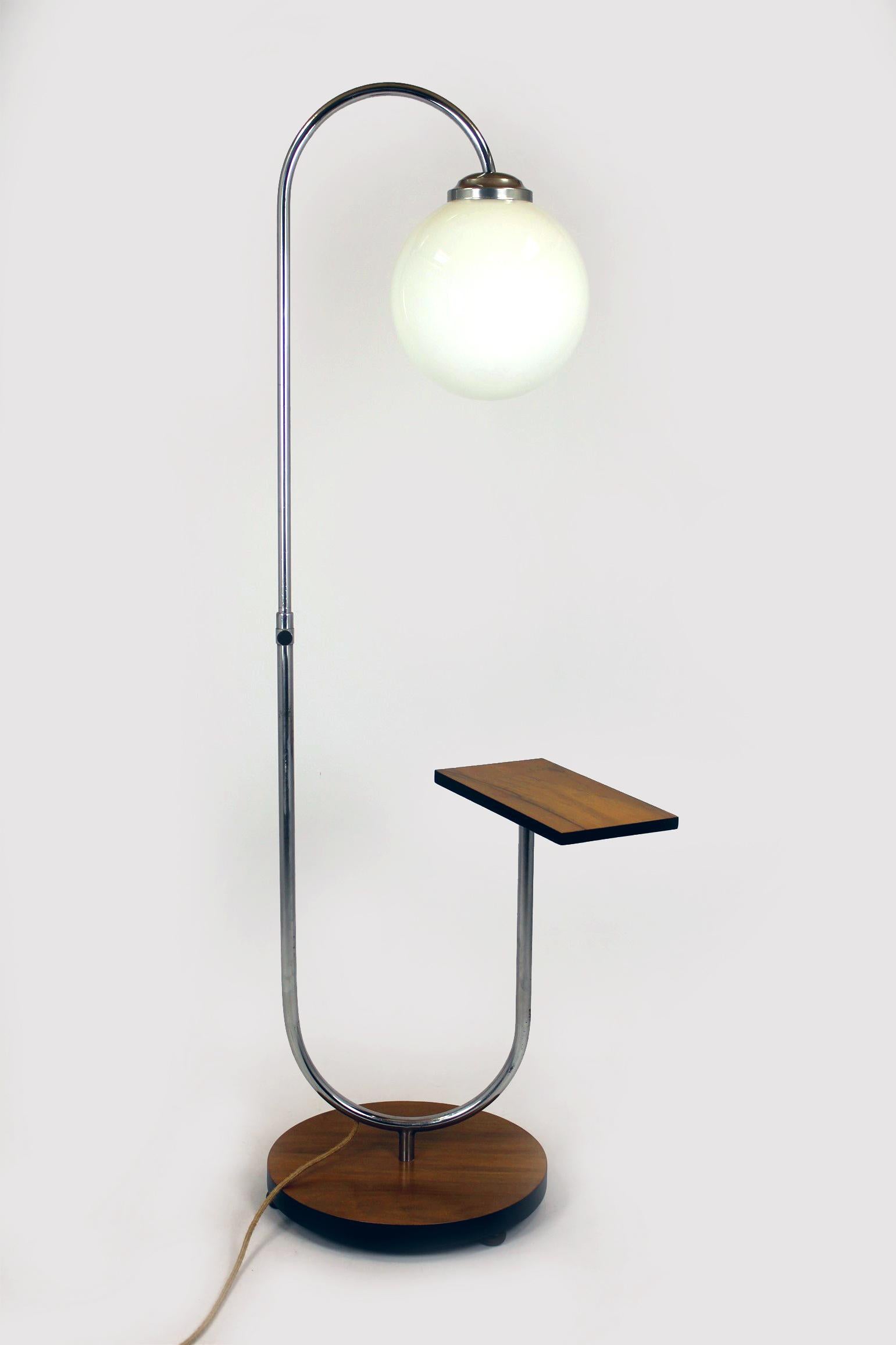 This Bauhaus floor lamp was designed by Jindrich Halabala and manufactured in the Czech Republic in the 1940s. The lamp has been refurbished - it has a new electric cable, floor switch and plug, all in a retro style. The wooden elements have been