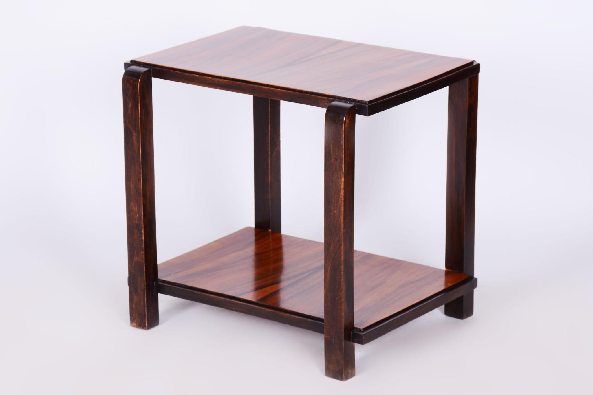 This elegant Art Deco console table comes from France from the first half of the 20th century. It is made of beech wood with walnut veneer and has undergone careful restoration.

The table has a stable construction and its original polish has been
