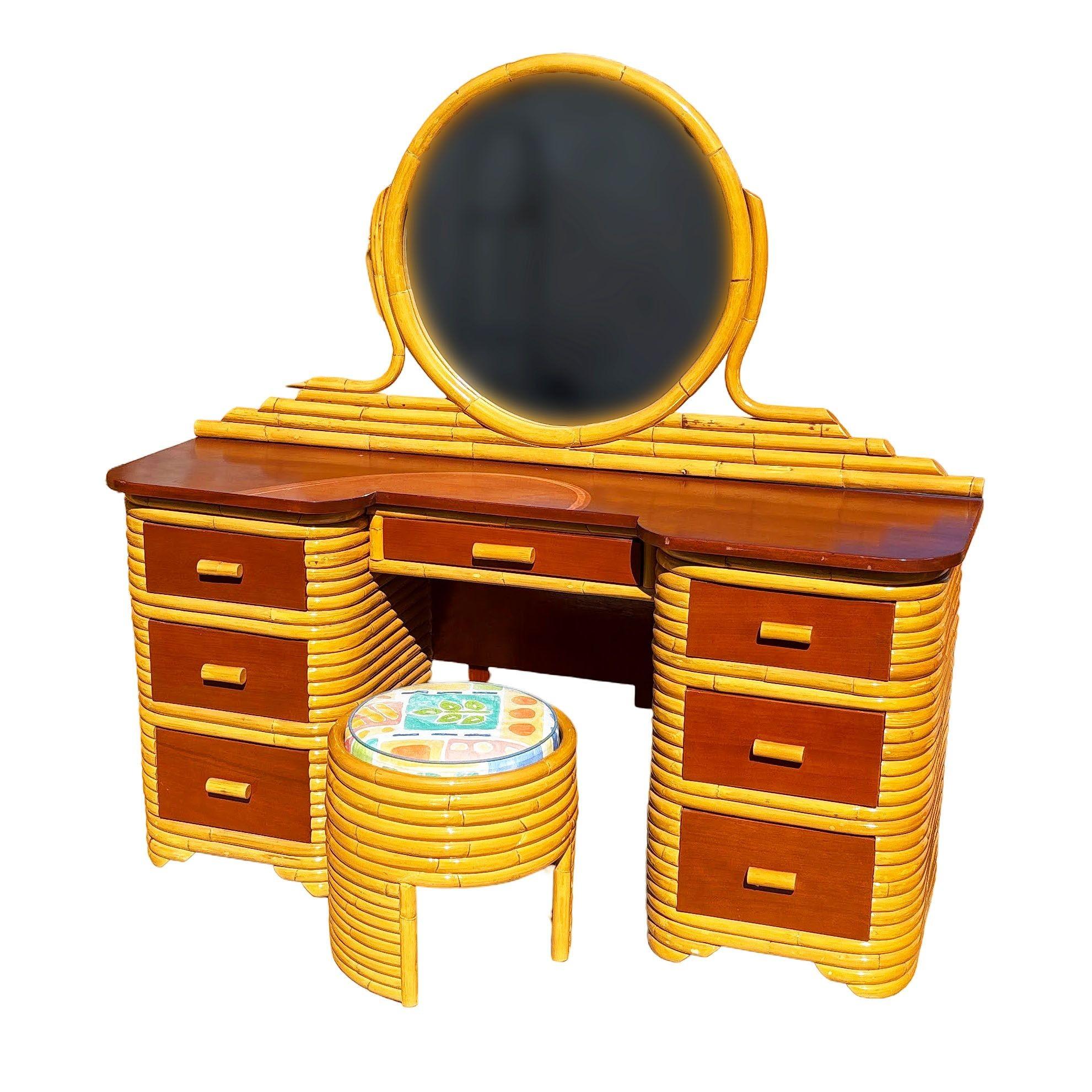 This beautifully restored horizontal-stacked rattan vanity blends vintage style charm with modern comfort. It features a Filipino mahogany table top, drawer fronts, and a round mirror. The vanity features a cut-out for sitting and six side drawers