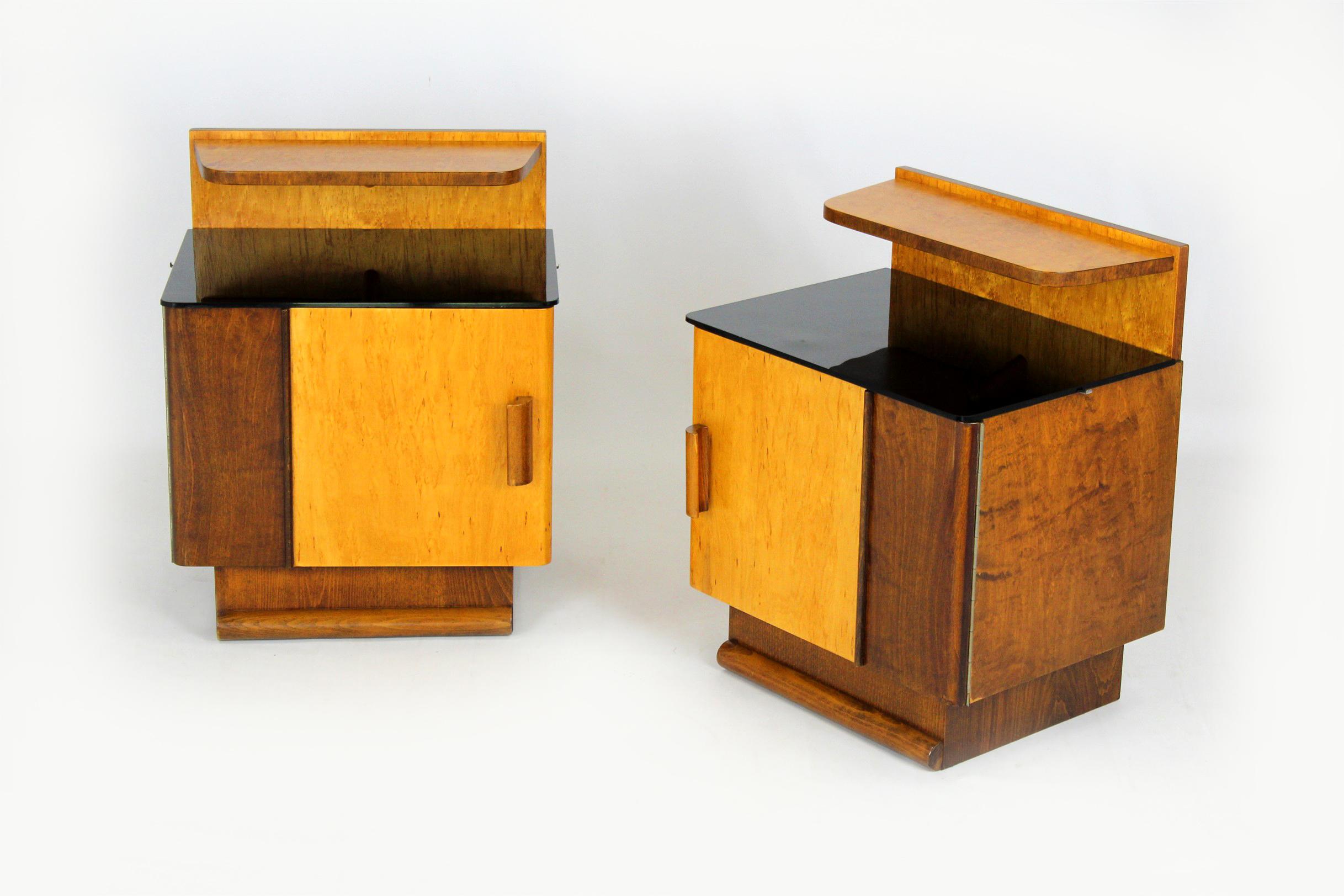 
A pair of bedside tables produced in Czechoslovakia in the 1950s.
The bedside tables have been fully restored, lacquered in a satin finish. Original black glass tops (with minor scratches). Please send us a message with your postcode to provide an