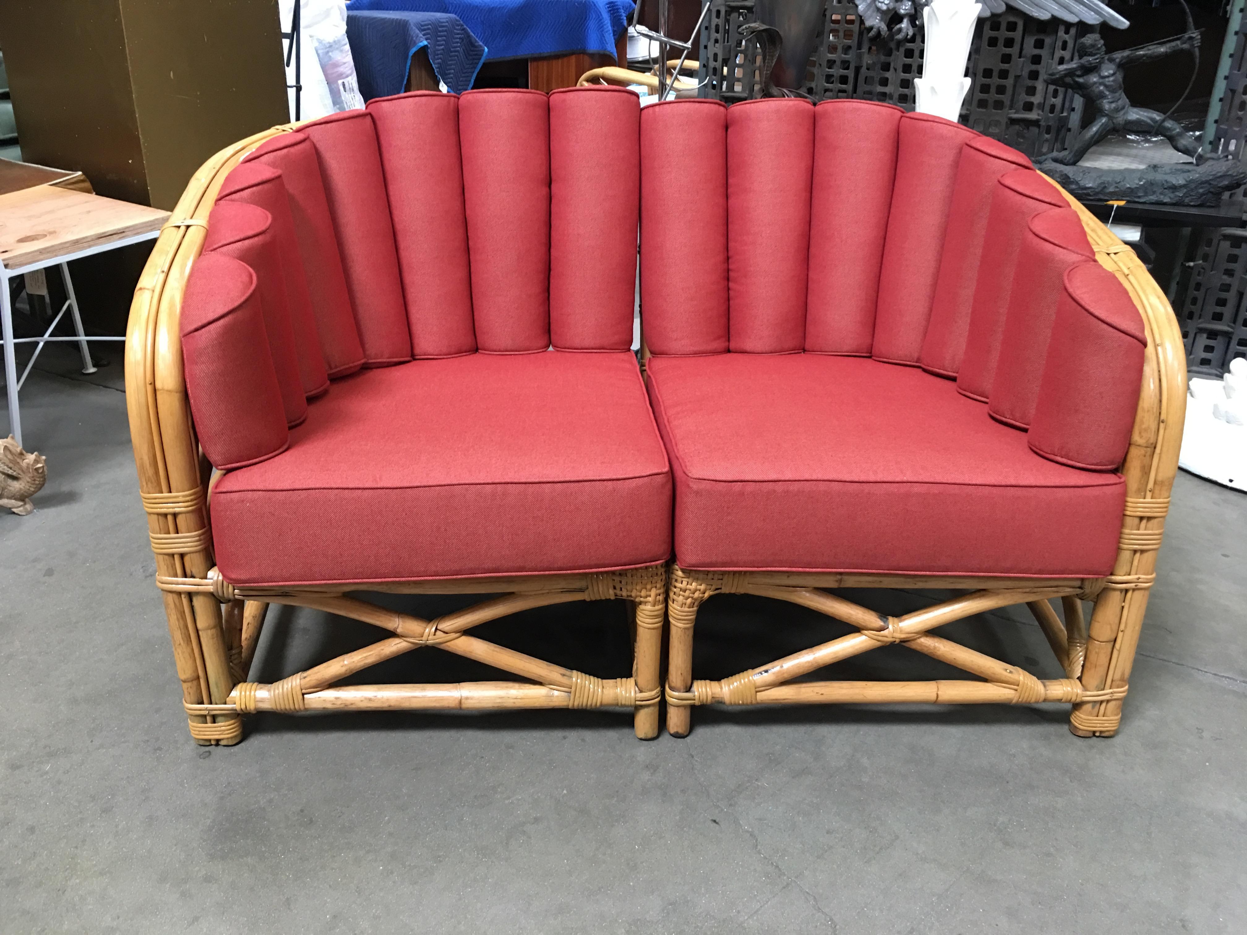 1930s Art Deco sectional two-seat rattan sofa features a red shell back seat around the perimeter of the backrest and X base. Restored to new for you. C.O.M. additional is available by request.  All rattan, bamboo and wicker furniture has been