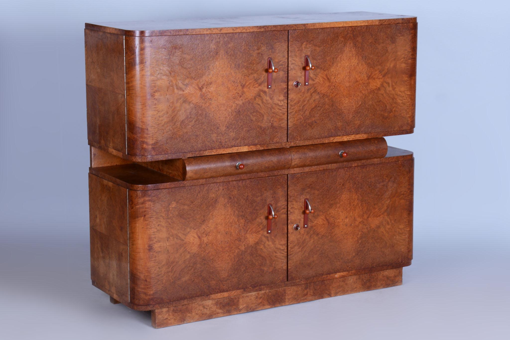 An elegant Art Deco secretary from the 1920s, crafted in Czechoslovakia under the direction of Jindřich Halabala for UP Závody. This extraordinary piece of furniture is a masterpiece combining rare woods – the exterior is veneered with thuja, while