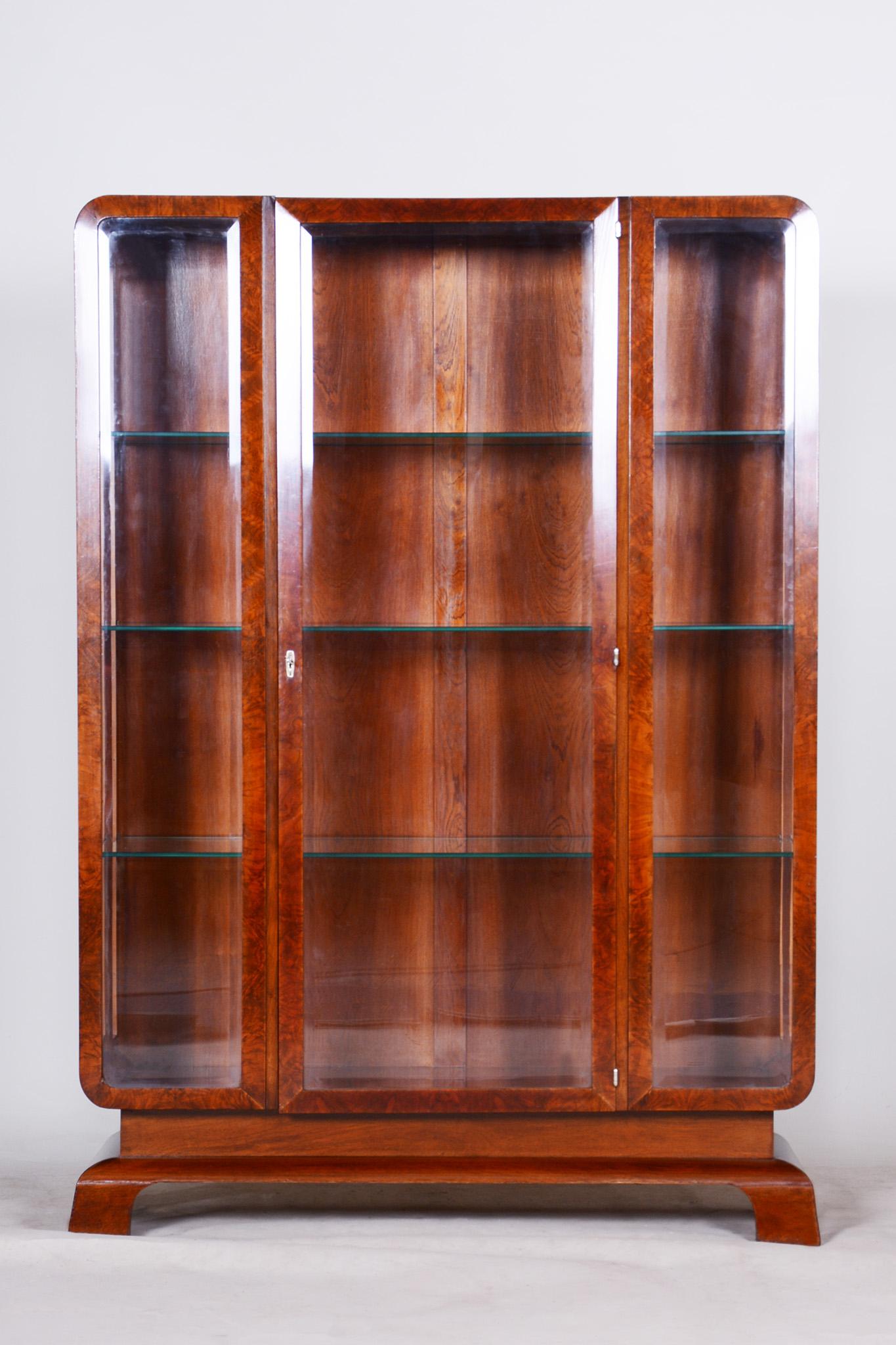 Restored Art Deco walnut display cabinet.

Source: Czechia
Period: 1930-1939
Material: Walnut

Revived original varnish.

This item features classic Art Deco elements. Art Deco is a style that originates from France in the early 20th