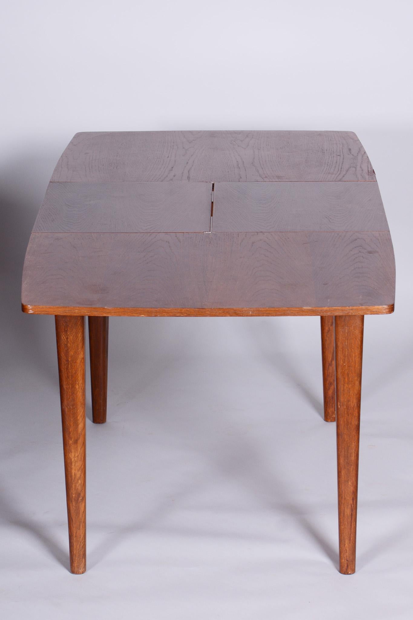 Restored Art Deco oak dining table.

Designer: Jindrich Halabala
Maker: UP Zavody
Period: 1940-1949
Source: Czechia
Adjustable width: 121 cm - 163 cm (47.6 in - 64.2 in).

Designed by Jindrich Halabala, renowned designer credited with