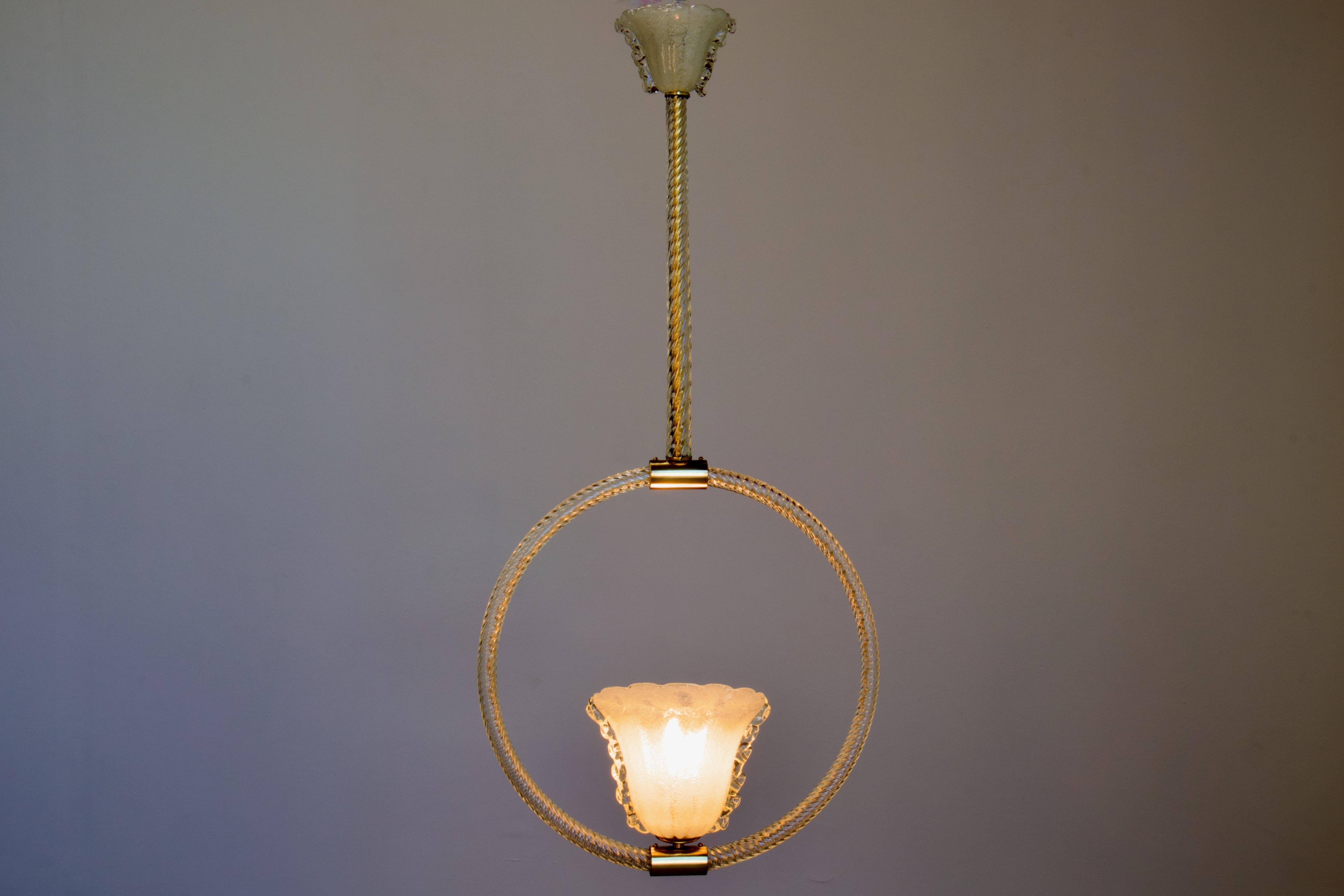 Stunning, fully restored, 1930s Italian Art Deco Pendant By Barovier & Toso. Made of Murano Glass, hand made in Venice, Italy, this fixture features a polished brass frame, wrapped in transparent twisted art glass, and supporting a Pulegoso (bubbled