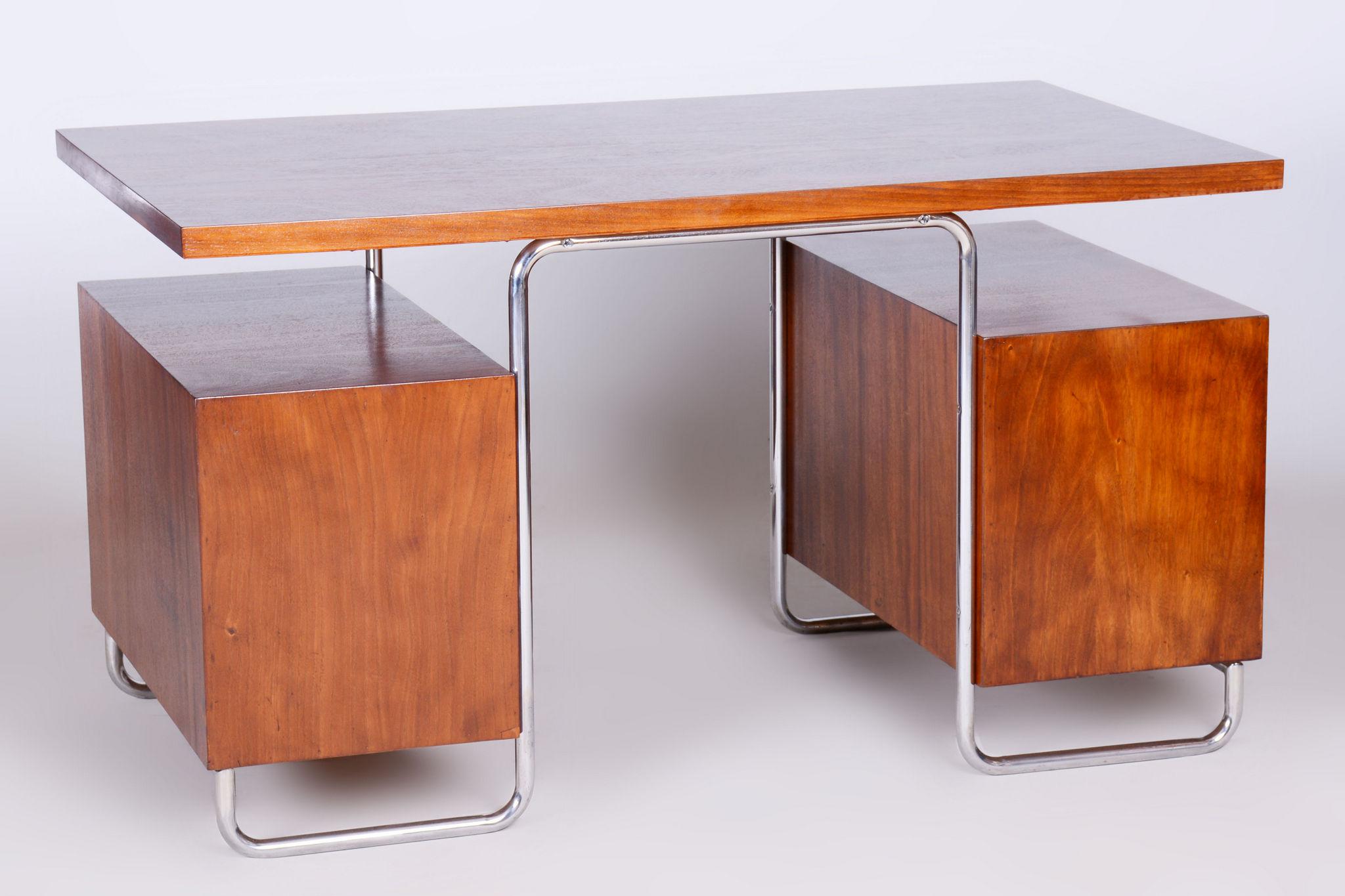 Restored Bauhaus Beech Writing Desk Made by Hynek Gottwald.

Maker: Hynek Gottwald
Material: Beech, Chrome-plated Steel
Source: Czechia 
Period: 1930-1939
Newly varnished wood.
The chrome parts have been cleaned and professionally restored. 

Leg