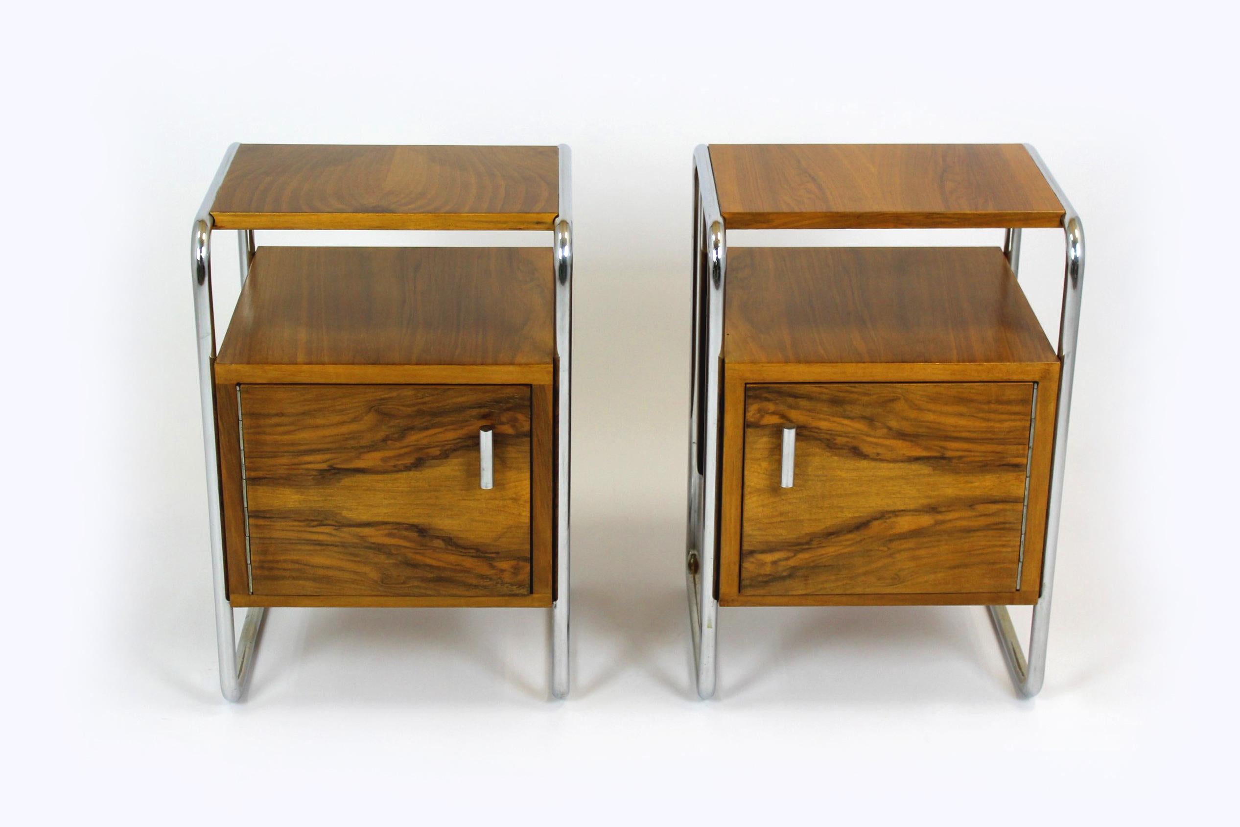 This pair of nightstands was manufactured by Robert Slezak in the 1940s. The frame is made of chrome tubular steel, the cabinets are walnut. The tables have been restored, the wood is varnished in a satin finish. Chrome elements have been polished,