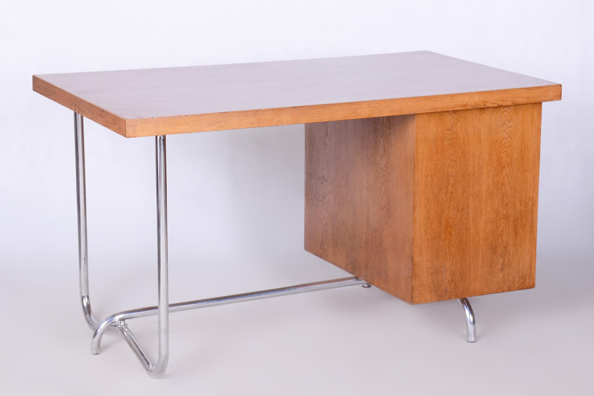 Restored Bauhaus Oak Writing Desk by Hynek Gottwald.

Period: 1930-1939
Source: Czechia (Czechoslovakia)
Material: Oak, Chrome-Plated Steel
Leg space:
Height: 74,5 cm (29.3 in)
Width: 77 cm (30.3 in)

Revived polish. The chrome parts have been