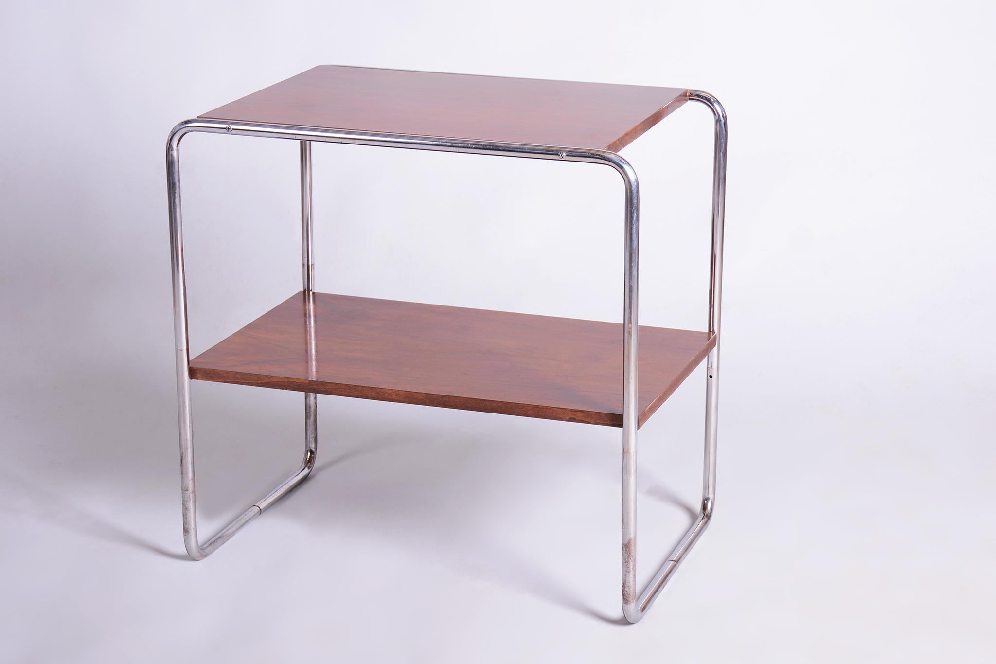 This elegant Bauhaus style table comes from Czechoslovakia from the 1920s. It features a tubular chrome steel frame, which has been professionally cleaned. The tabletop is made of blockboard veneered with walnut and has undergone careful restoration
