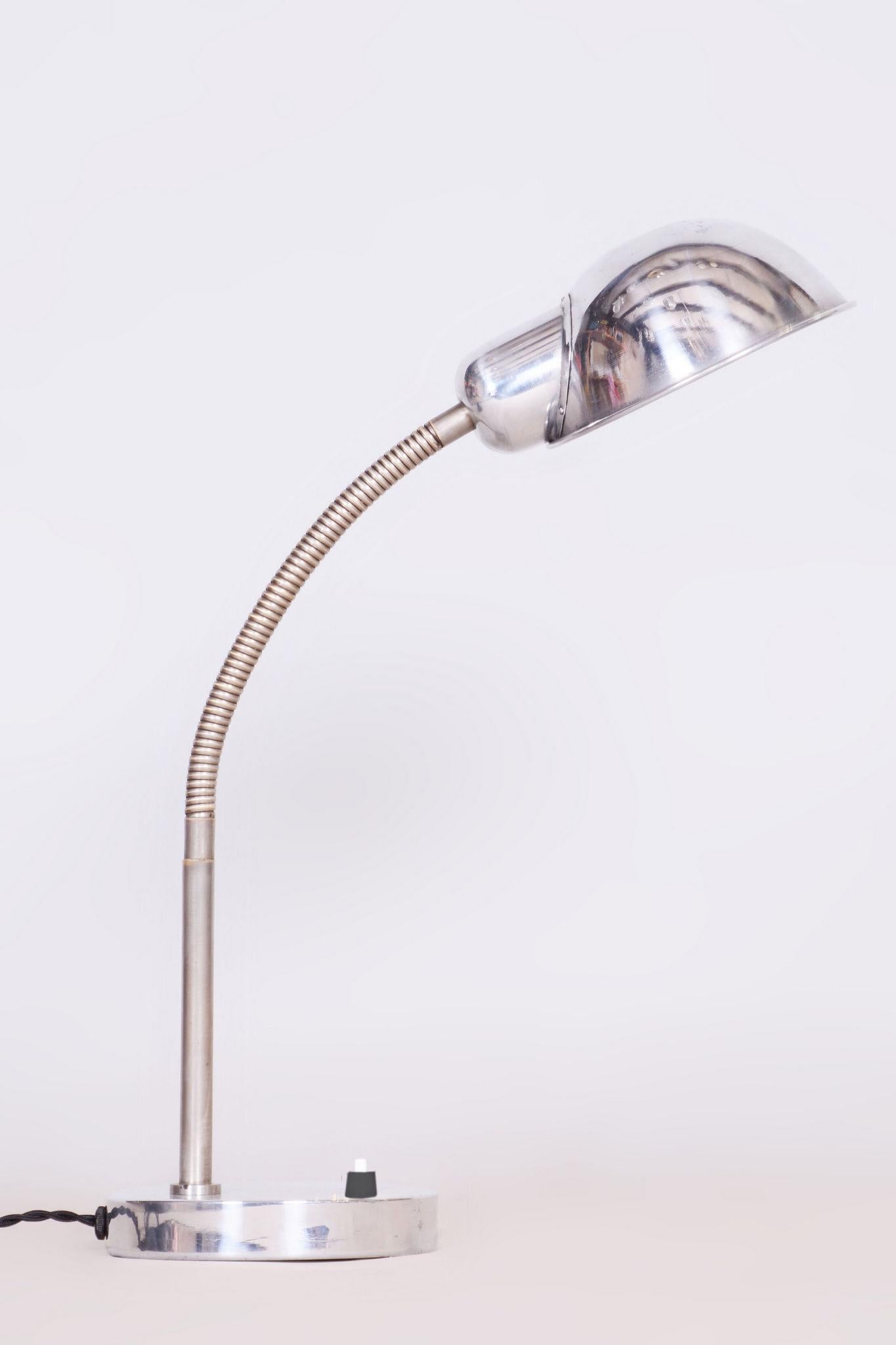Restored Bauhaus table lamp. 

Period: 1930-1939.
Material: Chrome-plated steel, aluminium (lamp shade) 
Source: Czechia

The chrome and aluminium parts have been cleaned, polished and professionally restored. Our professional refurbishing team in
