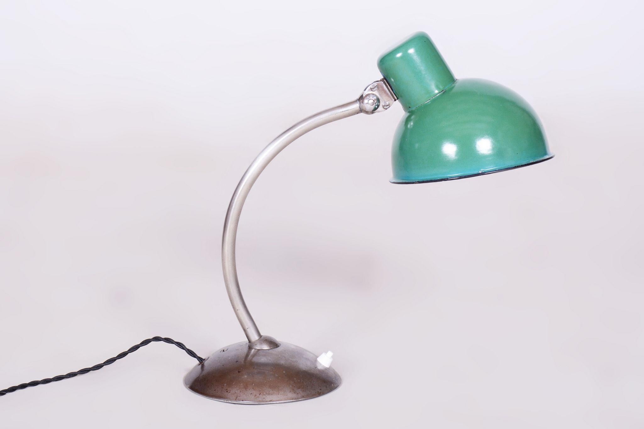 Restored Bauhaus Table Lamp With New Electrification.

Material: Chrome-plated Steel, Enameled Metal
Source: Czechia (Czechoslovakia)
Period: 1930-1939
New electrification.
Enameled metal light shade.
The chrome parts have been cleaned and