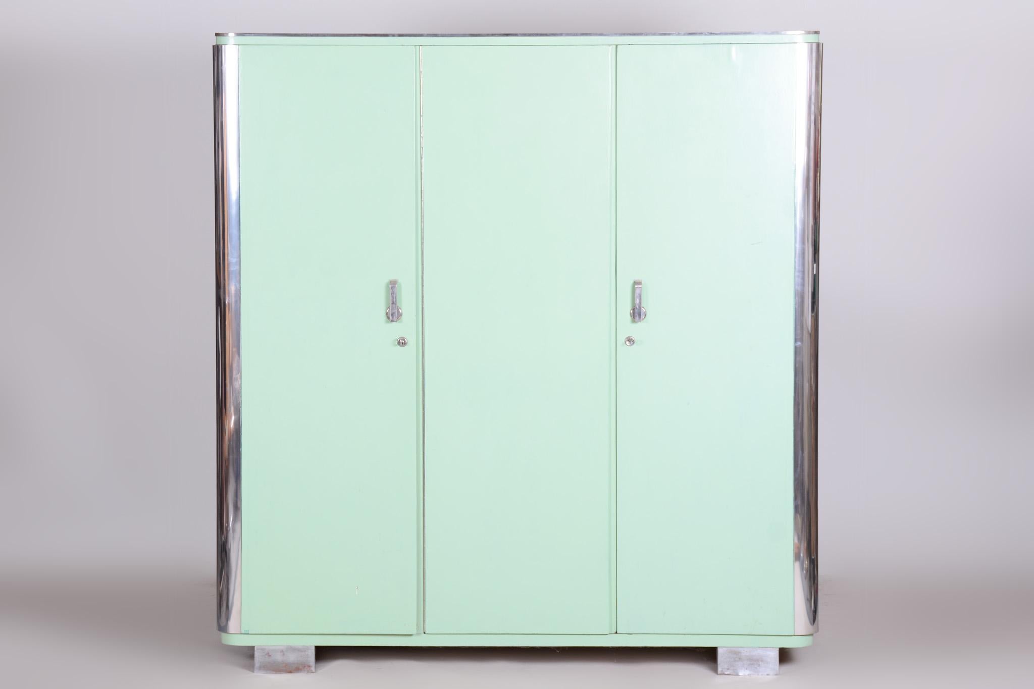 The chrome parts have been cleaned and professionally restored. 

This wardrobe from the 1930s is a fine example of Bauhaus design, crafted in Czechoslovakia by the renowned company Vichr & Co. Made from sturdy spruce veneered with oak, it showcases