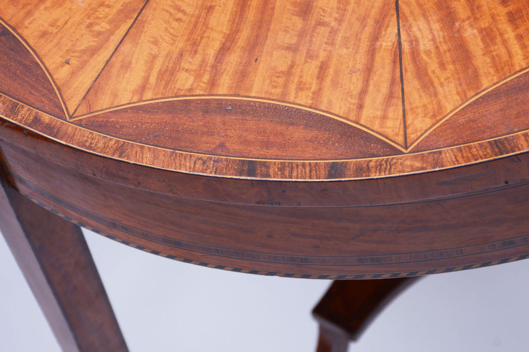 Restored Biedermeier Cherry-Tree Round Table. Uniquely extensive and detailed marquetry. Original polish. Brass wheels.

Source: France 
Period: 1850-1859 
Material: Cherry tree, Maple, Satinwood

Our professional refurbishing team in Czechia