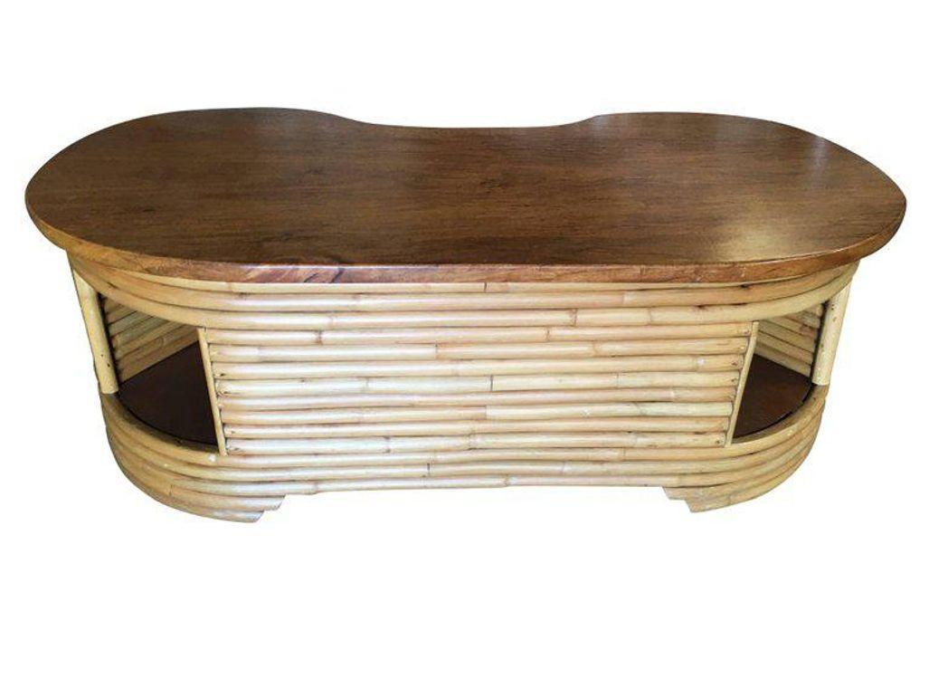 Biomorphic rattan coffee table with a Biomorphic shaped mahogany top and unique cubby storage underneath, circa 1950. This table features a stacked pole leg design and unique shape Restored to new for you.

1950, United States

We only purchase