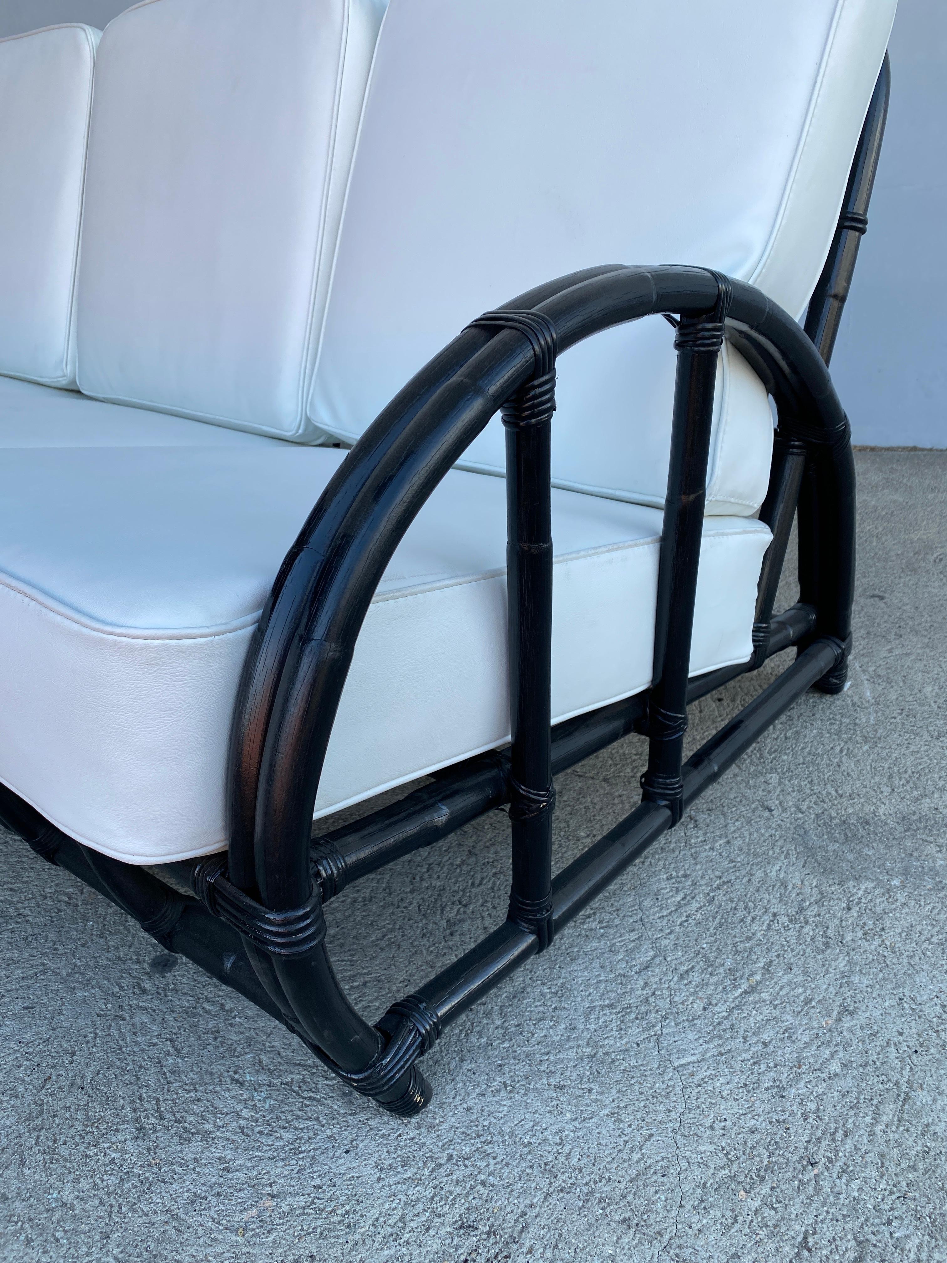 Mid-century era black 3-seater rattan sofa, with what we at the shop call the 