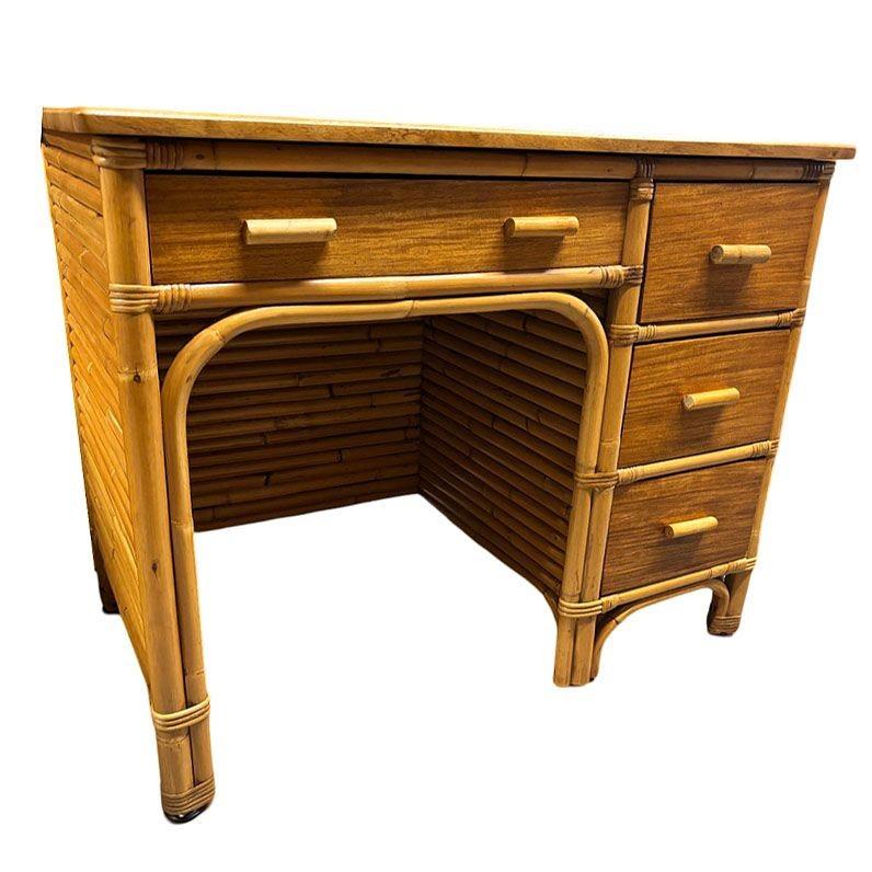 Experience the allure of tropical-inspired mid-century design with this Paul Frankl inspired restored rattan and mahogany writing desk. This desk features stacked rattan sides and mahogany drawer fronts, side panels, and a desktop. The desk features