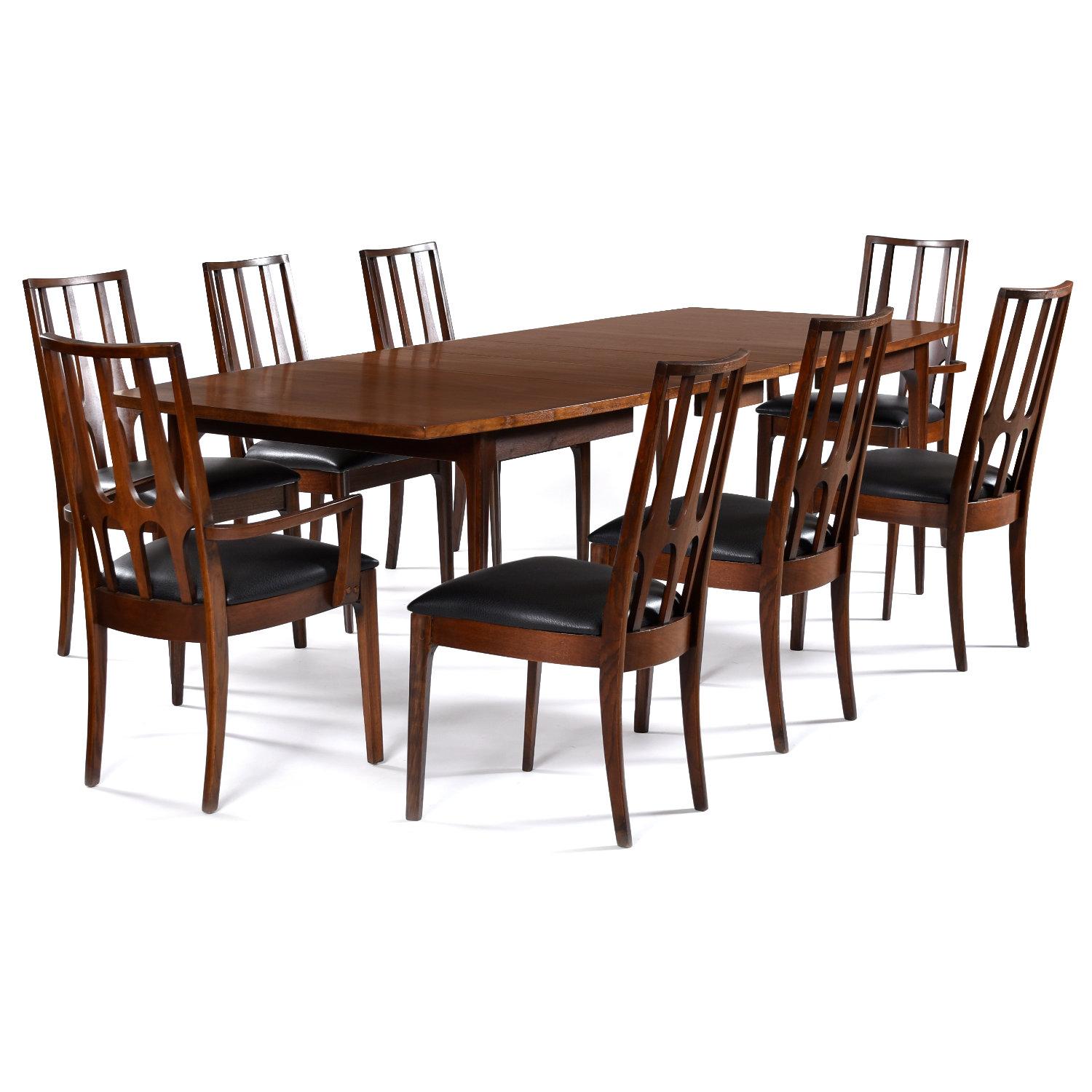Beautifully restored Broyhill Brasilia dining set. This sought after Mid-Century Modern walnut dining set includes an expanding dining table and 8 dining chairs. The table is 66? long and expands out to a maximum 102? in length. Three 12? leaves are