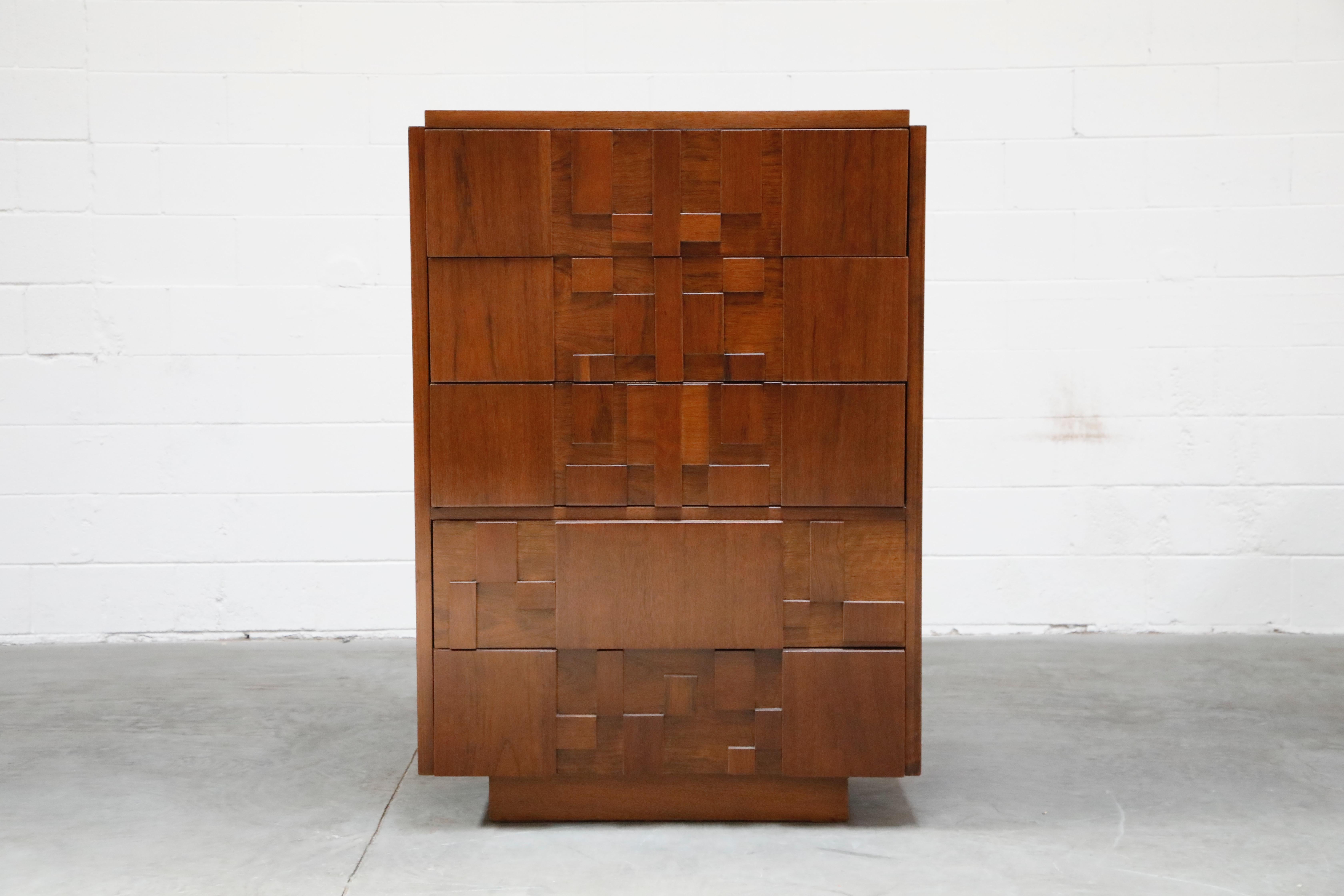 This fully restored Mid-Century Modern Brutalist highboy dresser, created by Lane, features a cubist style wood arrangement across the front of the five dresser drawers. Each of the blocks of wood has a rich and unique grain, each going a different