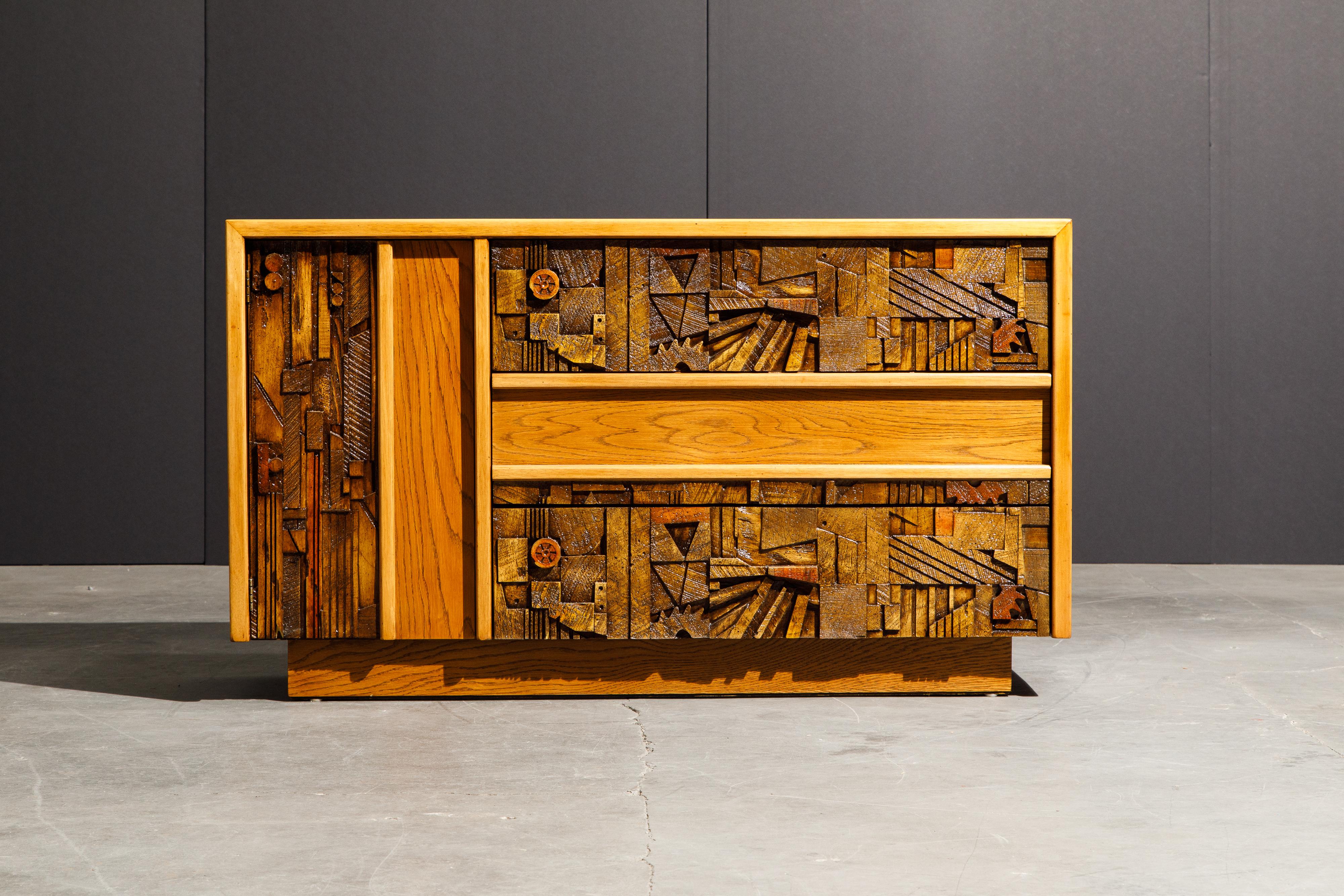 This fully restored 1960's Mid-Century Modern Brutalist cabinet, created by Lane, features a cubist style wood arrangement across the front. Each of the sections of wood have rich and unique shapes, color and grain, creating a collage of different