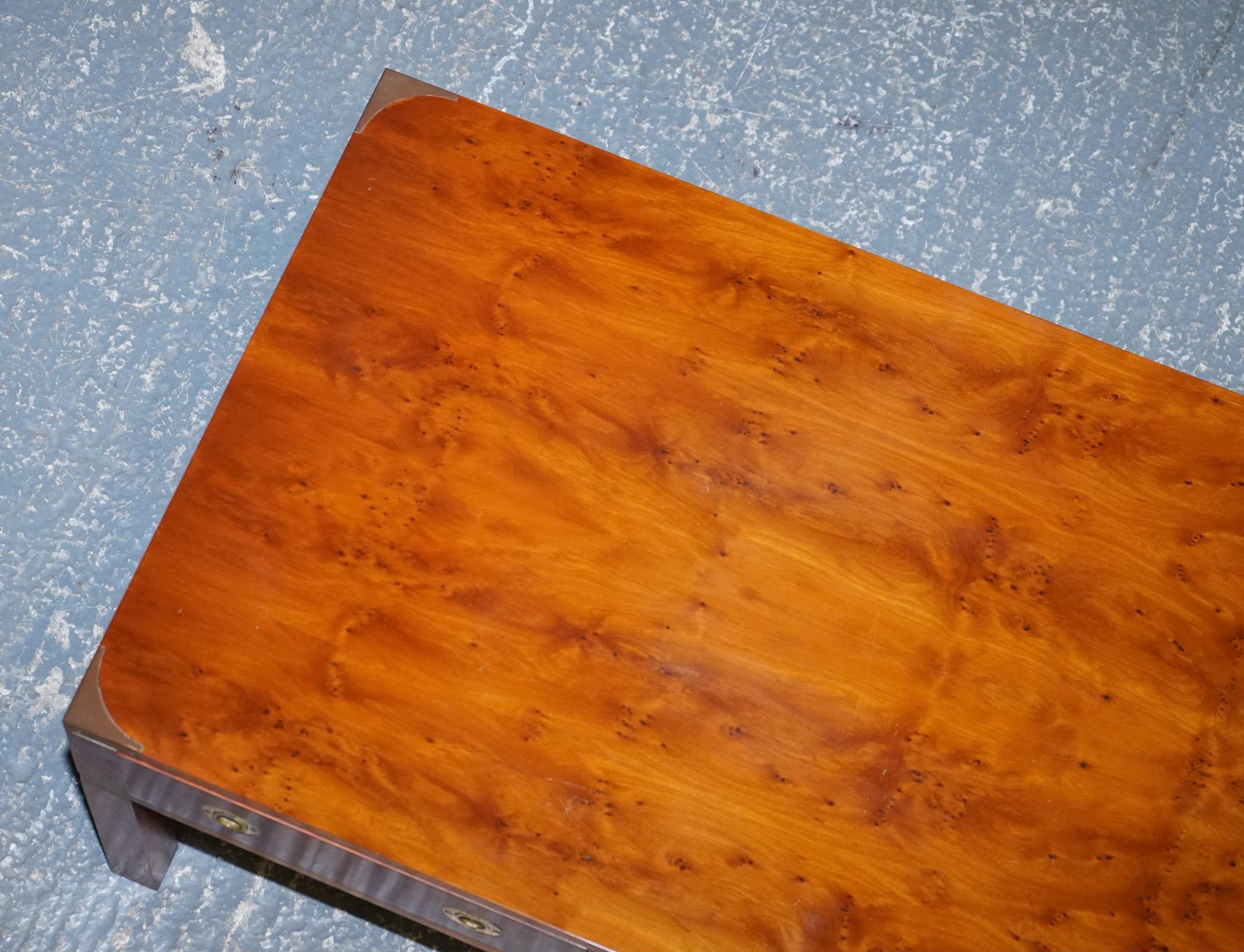 We are delighted to offer for sale this stunning burr yew & elm wood military campaign coffee table retailed by Harrods London.

This piece was retailed through Harrods London; they have used choice cuts of premium burr yew to make this excellent