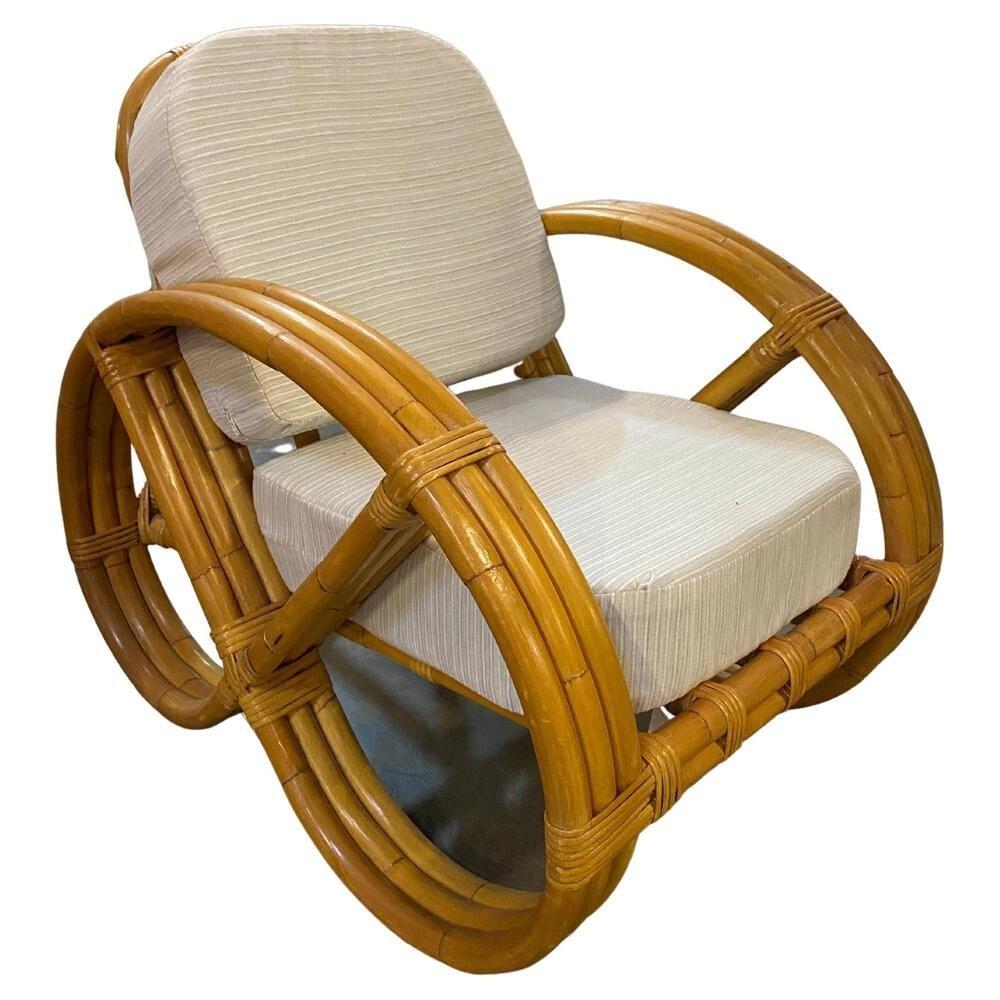 This beautifully restored Frankl style child-size or pet furniture size three-strand round full pretzel arm rattan living room set with a lounge chair and matching settee with fancy wicker wrappings. The set features white cloth cushions and 2 throw