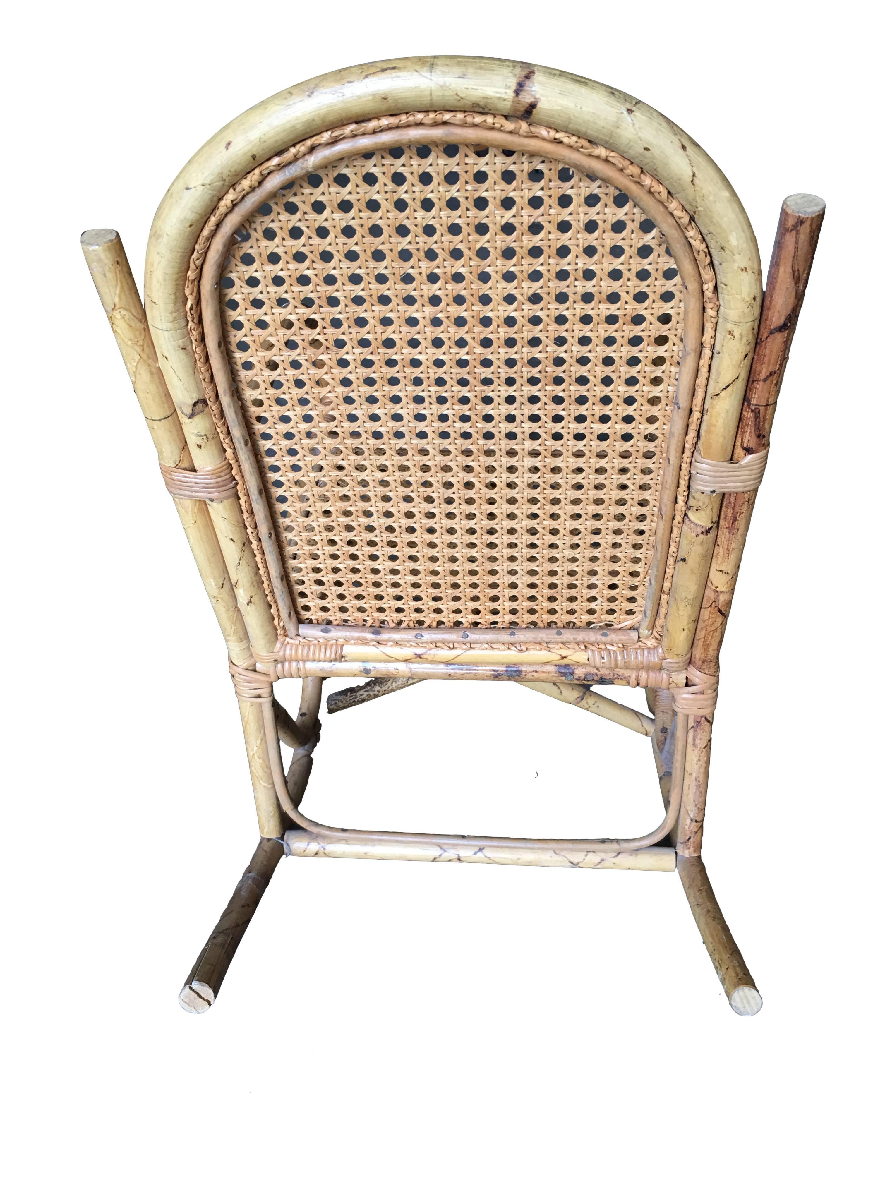 Rare child size Paul Frankl inspired single-strand pretzel arm rattan rocking chair with woven wicker seat, 
circa 1950.

This item can ship via UPS. Please let us know if you'd like that option better than 