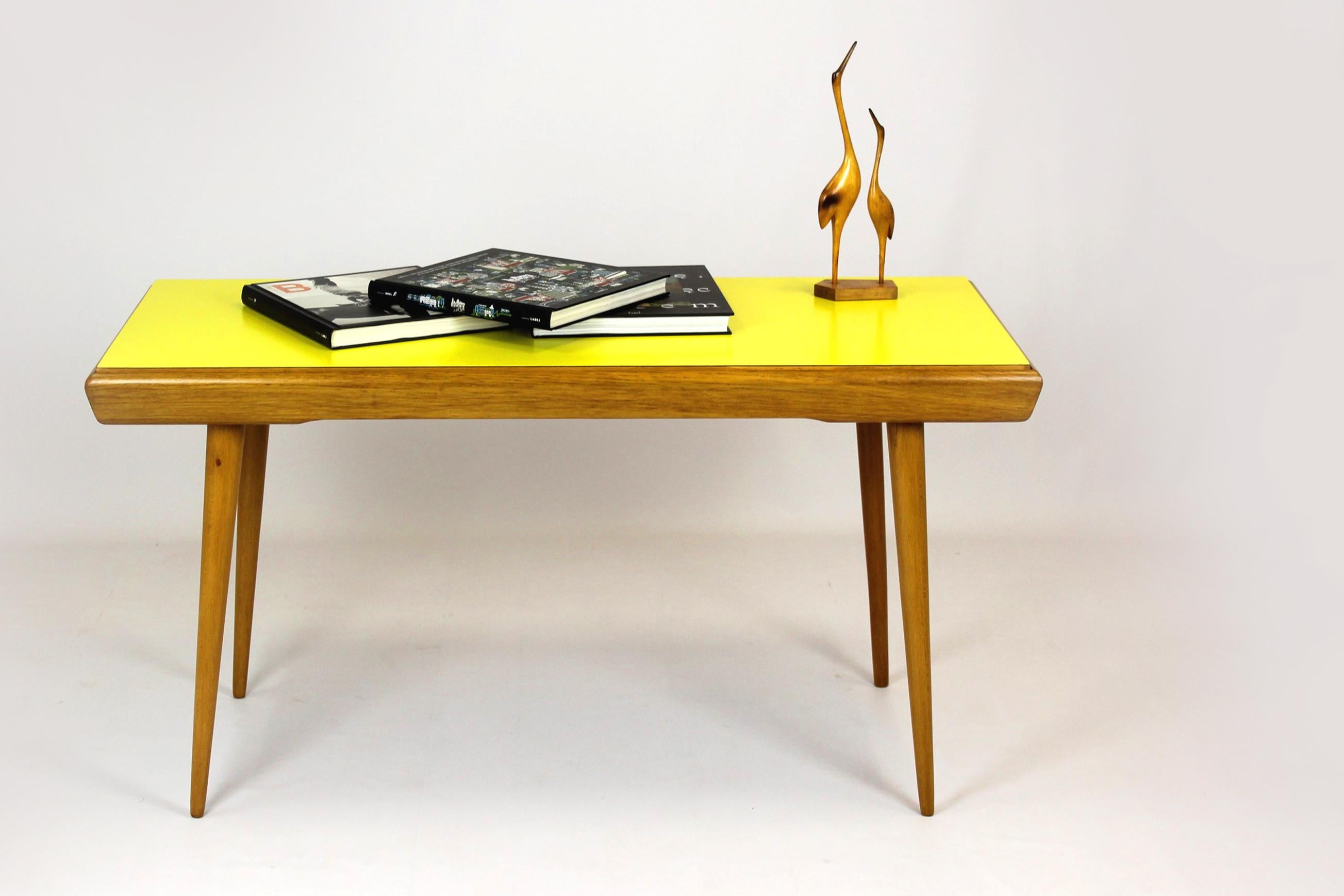 This coffee table with double-sided formica top was produced in the 1960s in Czechoslovakia. The table has been restored, lacquered in a satin finish. Formica tops preserved in original, very good condition, visible slight scratches.
