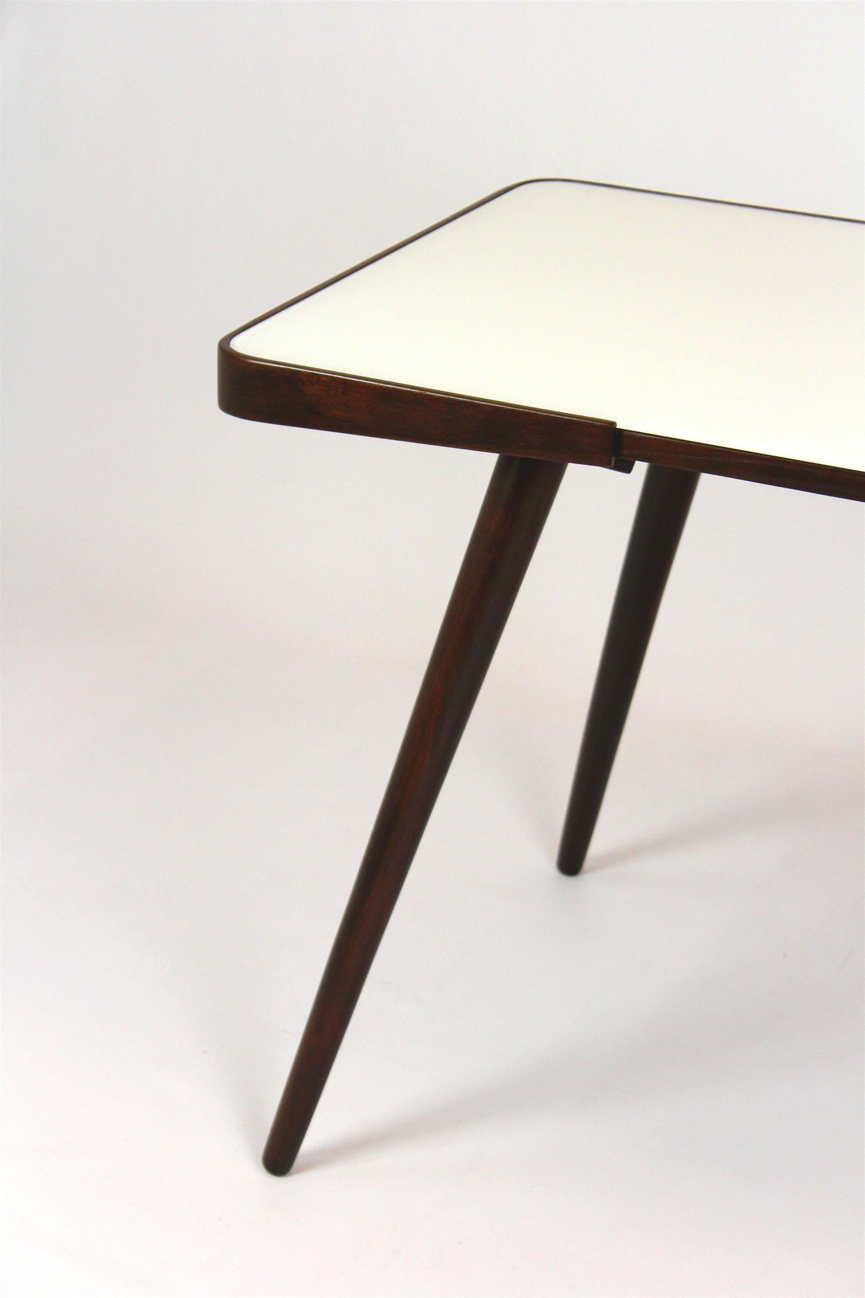 Coffee table with white glass top. Designed by Jiri Jiroutek and produced in the 1960s by Interier Praha. The table has been completely restored, lacquered wood, satin finished, new glass top.

