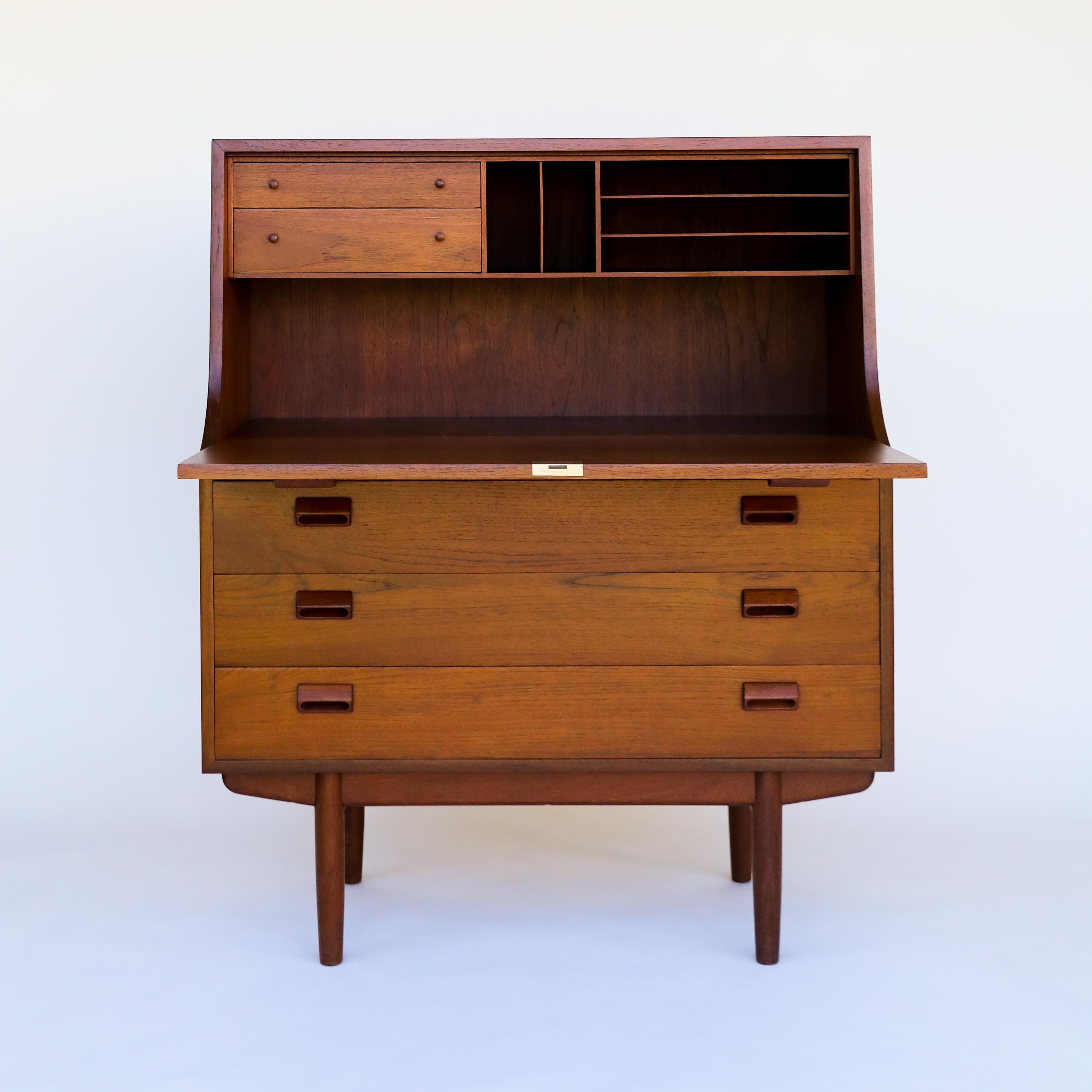 This piece has been restored to excellent condition!

Danish Secretary Desk by Børge Mogensen for Soborg Mobler, circa 1960's. This gorgeous teak drop-front secretary desk has three storage drawers. Tall tapered legs under a teak case gives this