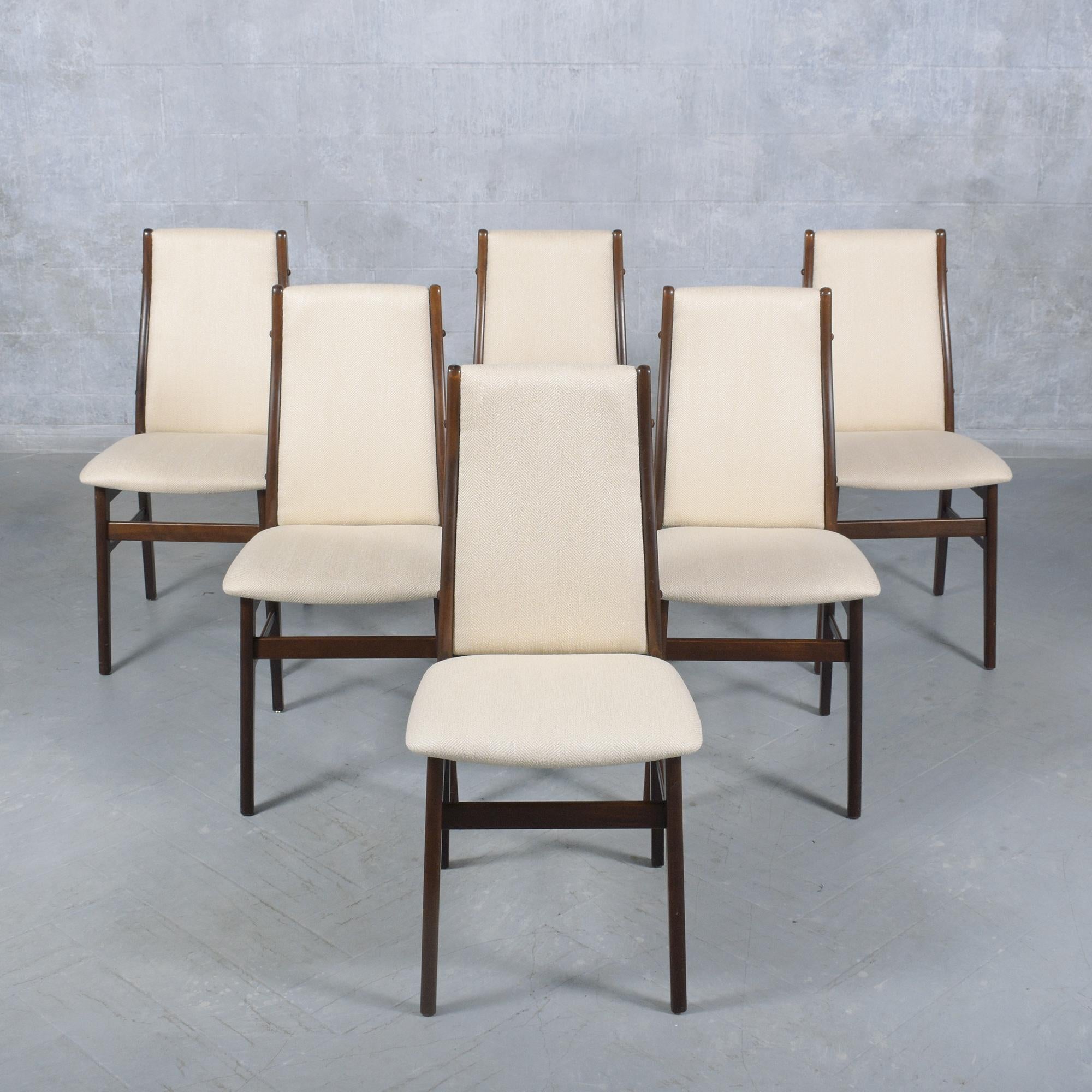 Experience the sophistication of Danish design with our set of six extraordinary dining room chairs, masterfully crafted from teak wood. This set has been completely restored, refinished, and reupholstered by our team of professional craftsmen,