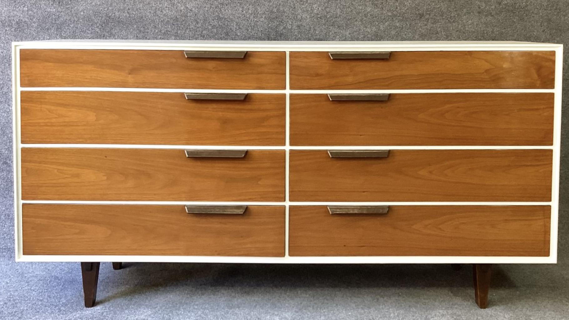 A stunning large double dresser in restored white enamel case, with warmly contrasting figured and book-matched walnut drawer fronts, having brown leather wrapped handles. This well-known and fully documented dresser is nevertheless rarely seen in
