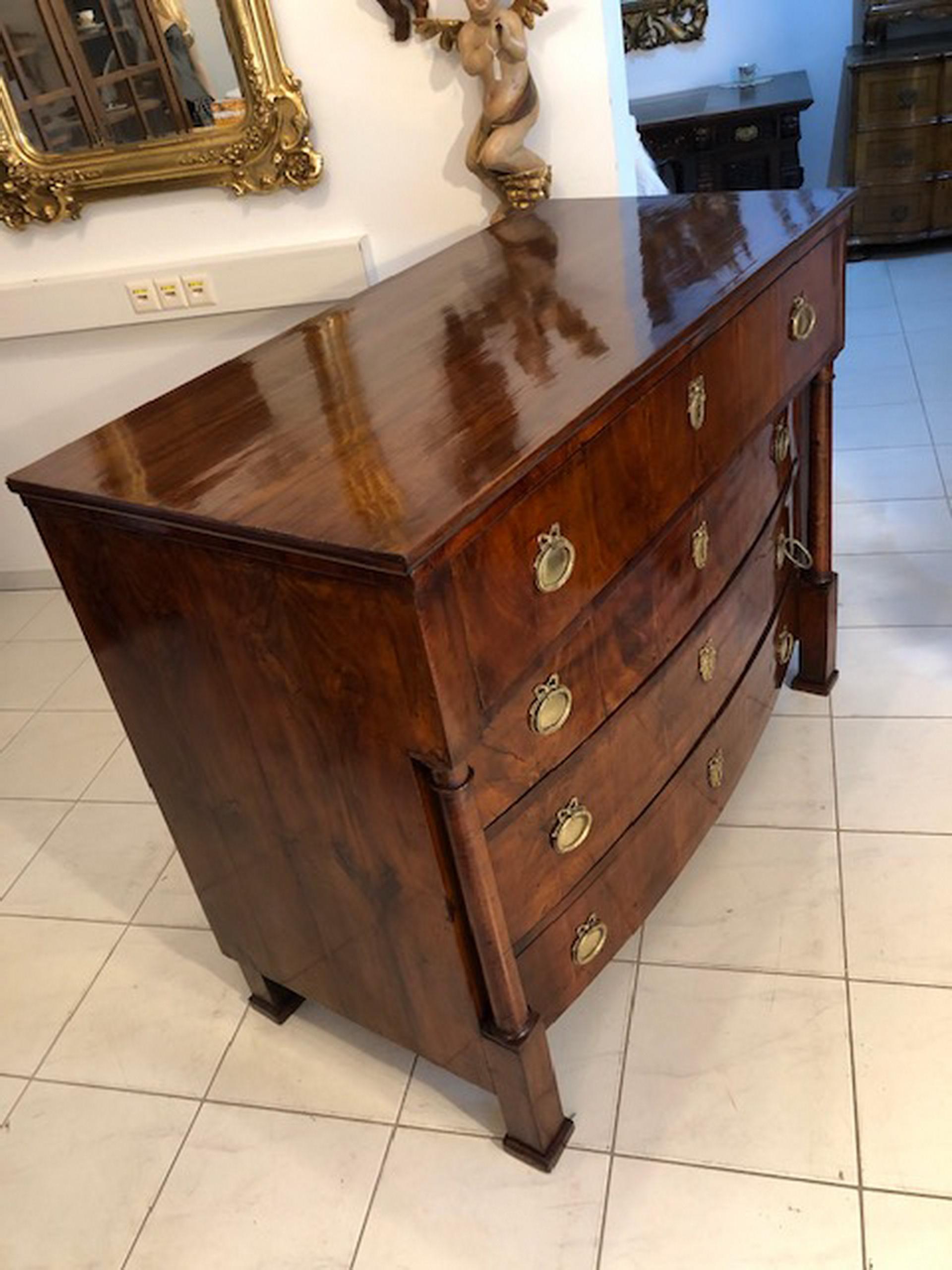 Original restored Empire era four-drawer dresser. This is a very nice Empire chest from circa 1815
which is especially beautiful as well as very noble and practical.
Very appealing design with a stunning veneer picture and features splendid