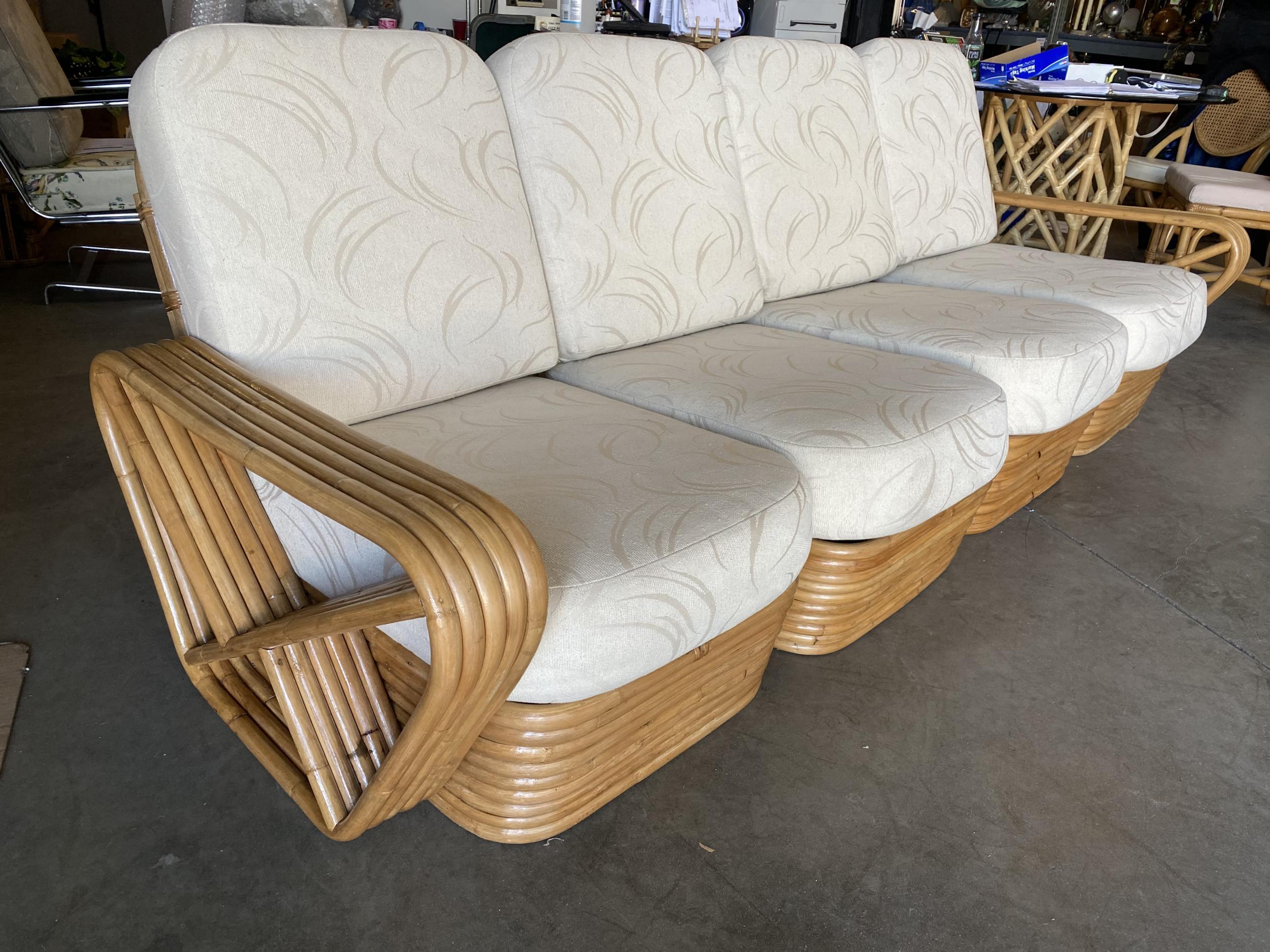 Paul Frankl style rattan living-room set including a matching four-seat sectional sofa and lounge chair. Both feature the famous six-strand square pretzel side arms and stacked rattan base originally designed by Paul Frankl.

Measures: 
Sofa 34
