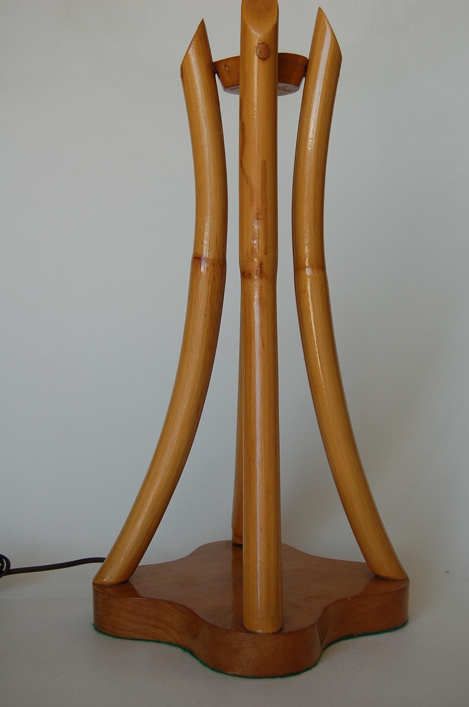 Restored pair of four-strand scalloped rattan bent pole table lamps on a mahogany base with brass center rob,

circa 1950.

Measures: 8