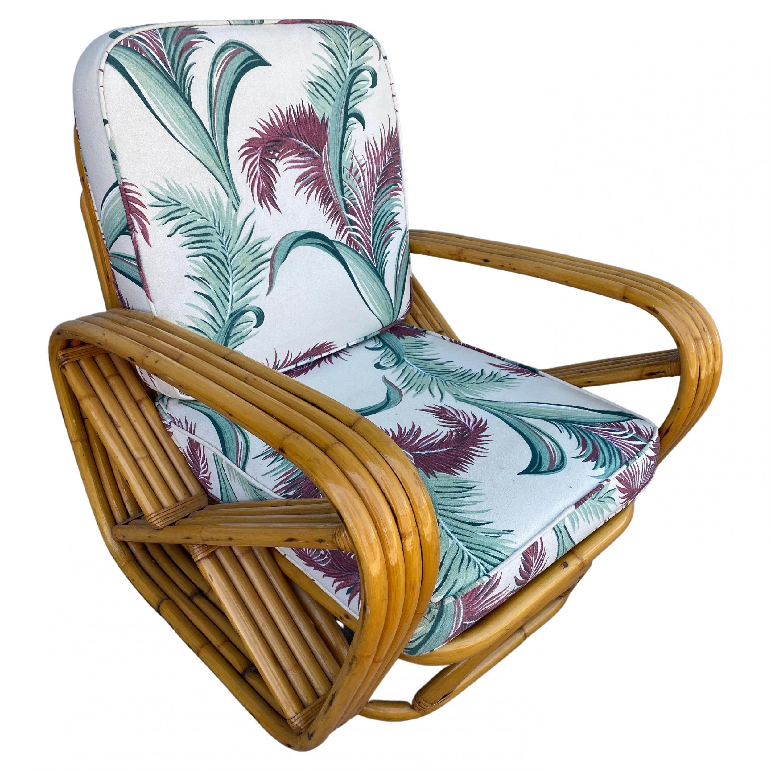 Designed in the manner of Paul Frankl, this four-strand rattan lounge chair features square pretzel arms and an open arched base.

Included is the matching stacked rattan ottoman.

Lounge chair: 33