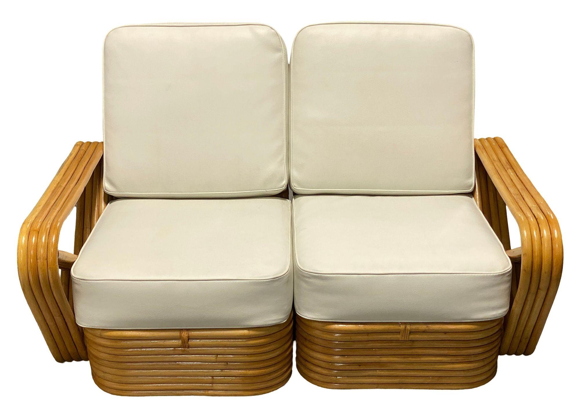 Original Mid-century six-strand rattan sectional settee featuring square pretzel arms and a classic stacked base. Made of steam-bent rattan poles, the sofa features decorative wicker woven wrappings of rattan strips in the form of Paul Frankl’s